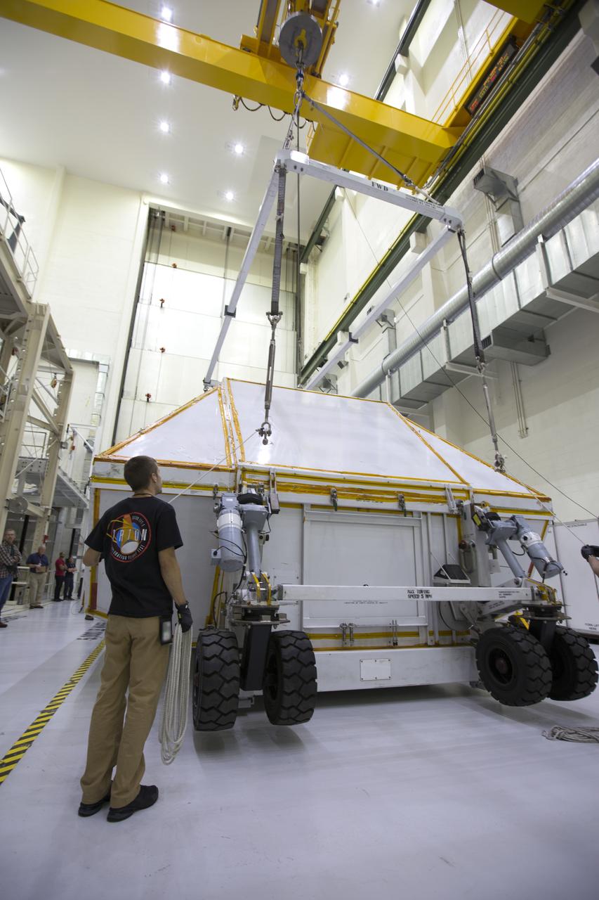 Inside the Neil Armstrong Operations and Checkout Building high bay at NASA's Kennedy Space Center in Florida, the Orion Exploration Mission-1 (EM-1) structural test article is secured inside its transport container. A crane is used to move the container toward a transport vehicle for the move to the Shuttle Landing Facility. The test article will be loaded in NASA's Super Guppy airplane and transported to Lockheed Martin's Denver facility for testing. The Orion spacecraft will launch atop NASA’s Space Launch System rocket on EM-1, its first deep space mission.