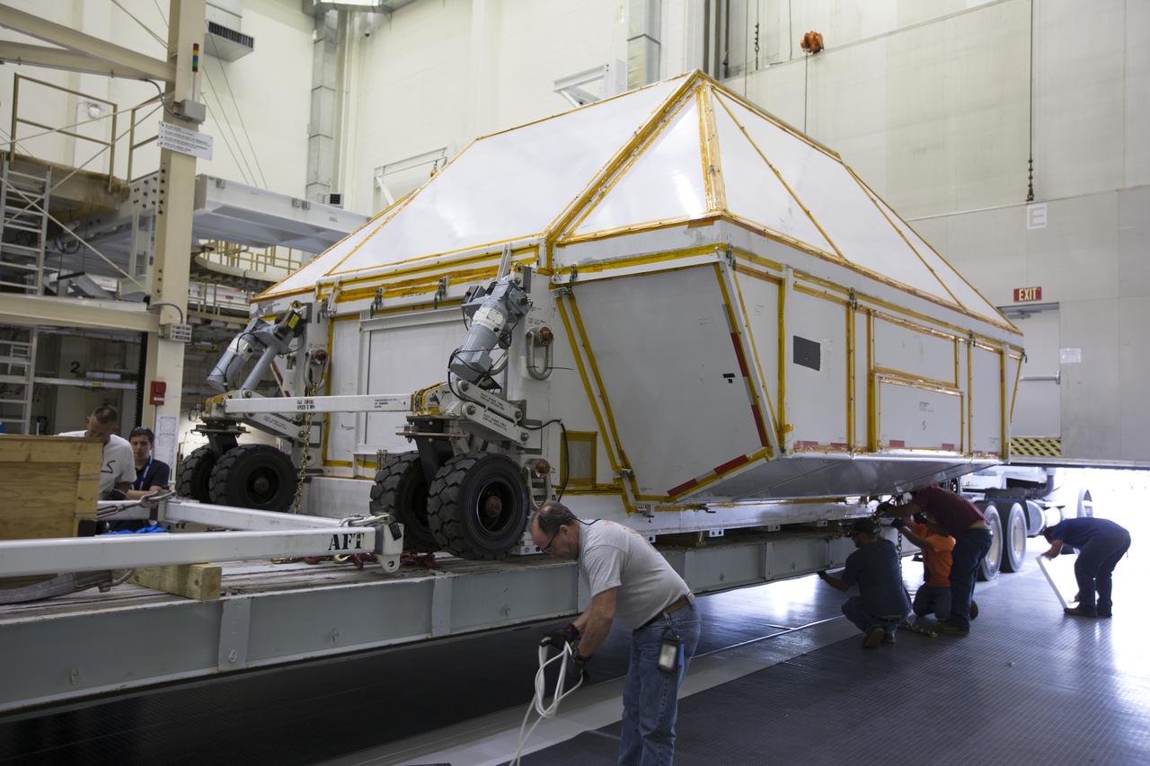 Inside the Neil Armstrong Operations and Checkout Building high bay at NASA's Kennedy Space Center in Florida, technicians secure the Orion Exploration Mission-1 (EM-1) structural test article in its transport container onto a transport vehicle for the move to the Shuttle Landing Facility. The test article will be loaded in NASA's Super Guppy airplane and transported to Lockheed Martin's Denver facility for testing. The Orion spacecraft will launch atop NASA’s Space Launch System rocket on EM-1, its first deep space mission. 