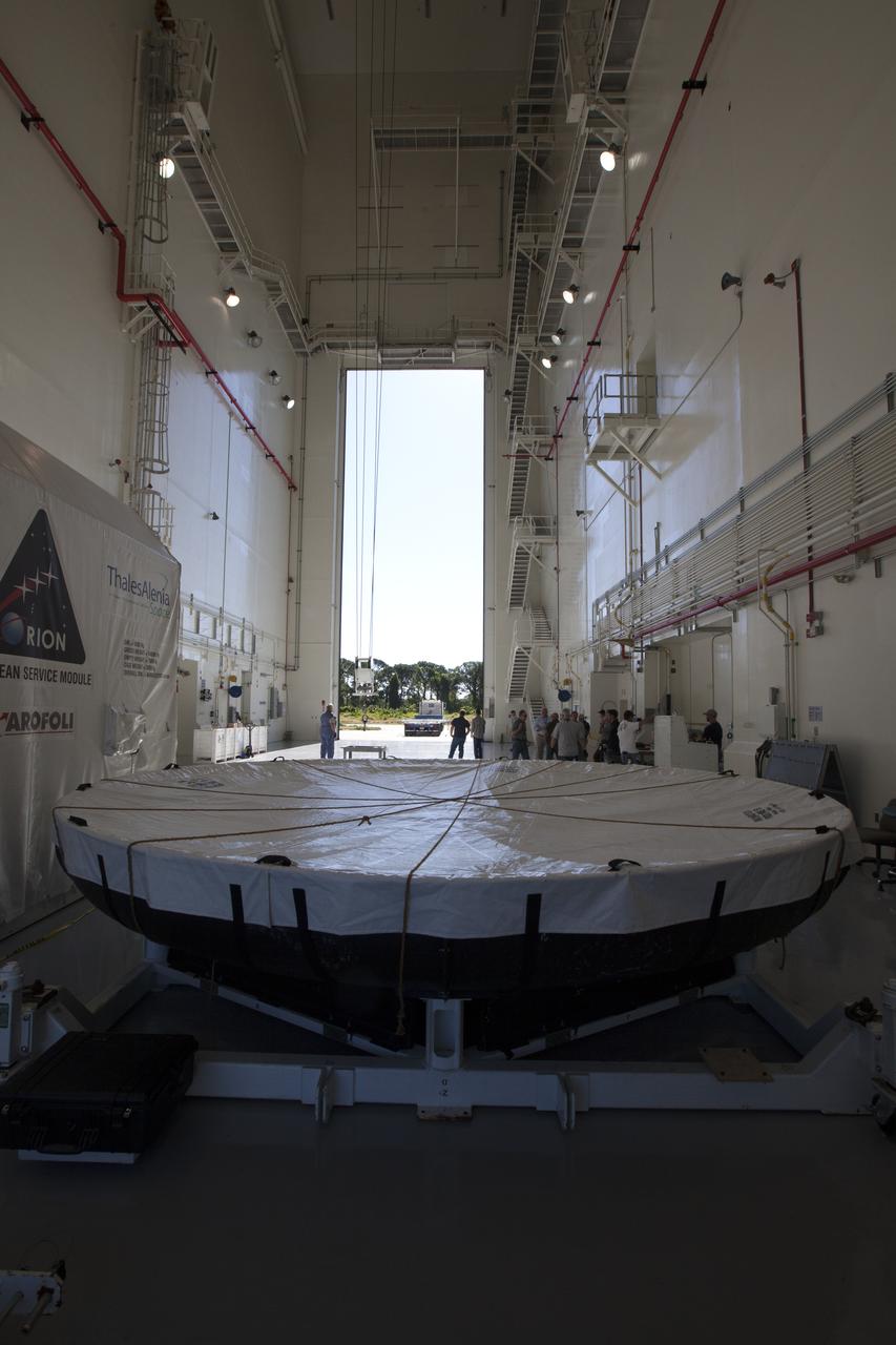 Inside the Launch Abort System Facility at NASA's Kennedy Space Center in Florida, the Orion heat shield from Exploration Flight Test-1 is being prepared for its move to the Vehicle Assembly Building (VAB). The heat shield is being transferred from the Orion Program to the Ground Systems Development and Operations Program, Landing and Recovery Operations. In the VAB, the heat shield will be integrated with the Orion ground test article and used for future underway recovery testing.