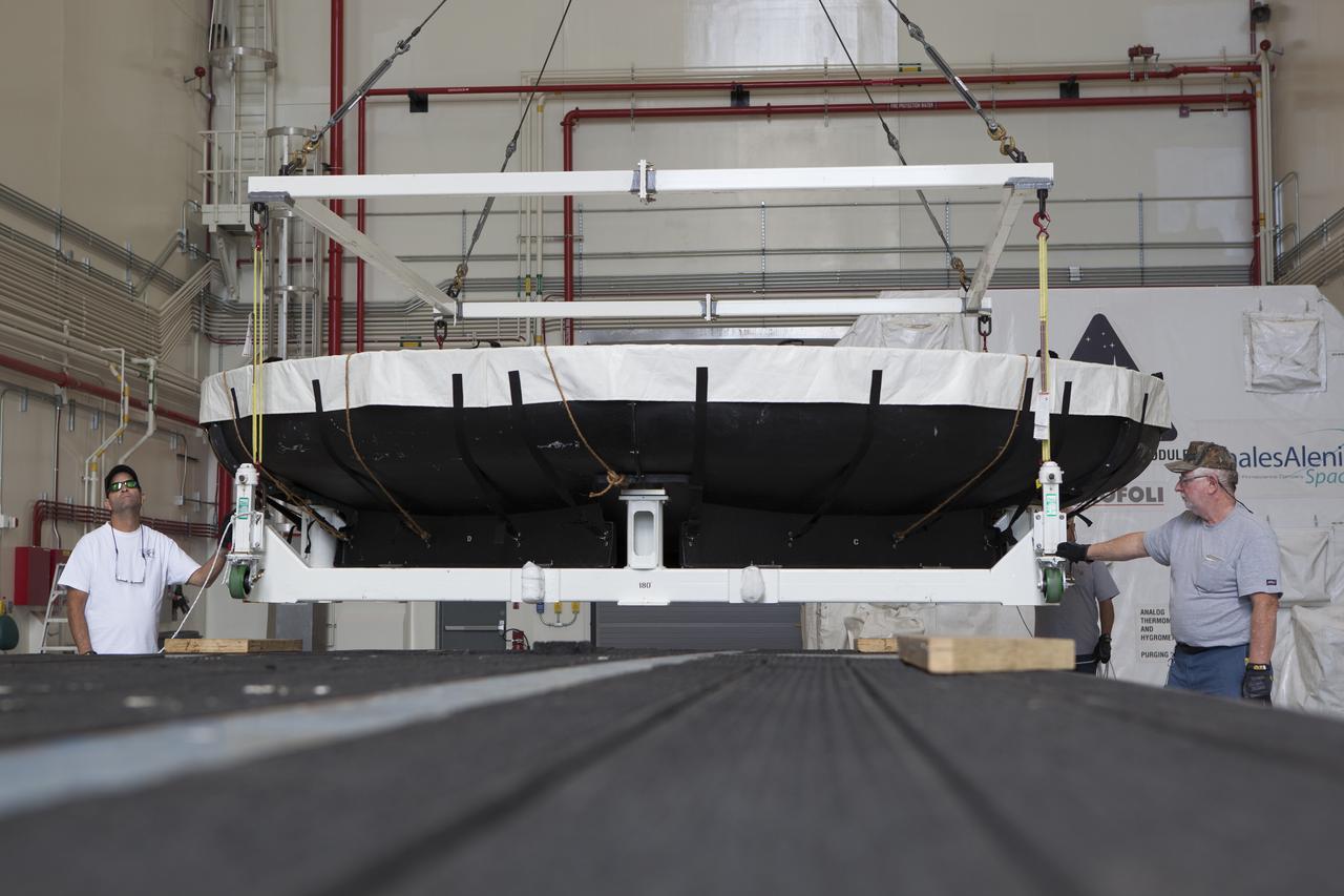 Inside the Launch Abort System Facility at NASA's Kennedy Space Center in Florida, the Orion heat shield from Exploration Flight Test-1 is being loaded onto a transporter for its move to the Vehicle Assembly Building (VAB). The heat shield is being transferred from the Orion Program to the Ground Systems Development and Operations Program, Landing and Recovery Operations. In the VAB, the heat shield will be integrated with the Orion ground test article and used for future underway recovery testing. 
