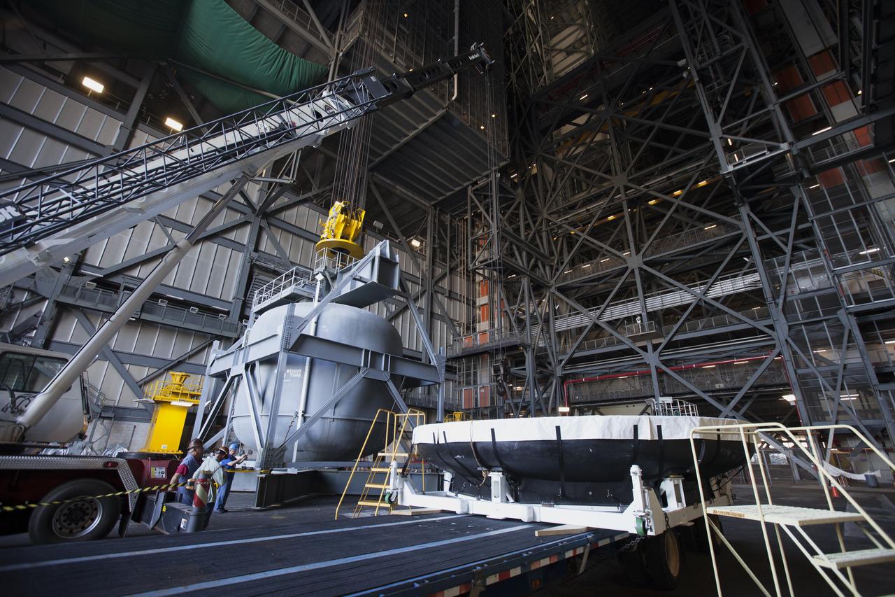 The Orion heat shield from Exploration Flight Test-1 has arrived in High Bay 2 of the Vehicle Assembly Building (VAB) at NASA's Kennedy Space Center in Florida. The heat shield is being transferred from the Orion Program to the Ground Systems Development and Operations Program, Landing and Recovery Operations. In the VAB, the heat shield will be integrated with the Orion ground test article and used for future underway recovery testing. 