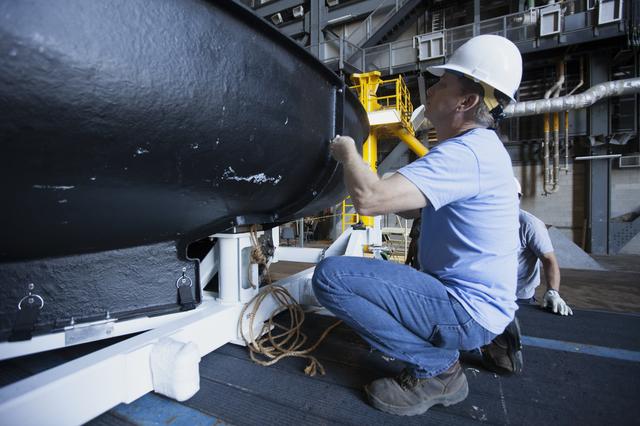 NASA image: Orion EFT-1 Heat Shield Offload from Truck onto Foam Pads (Dunna