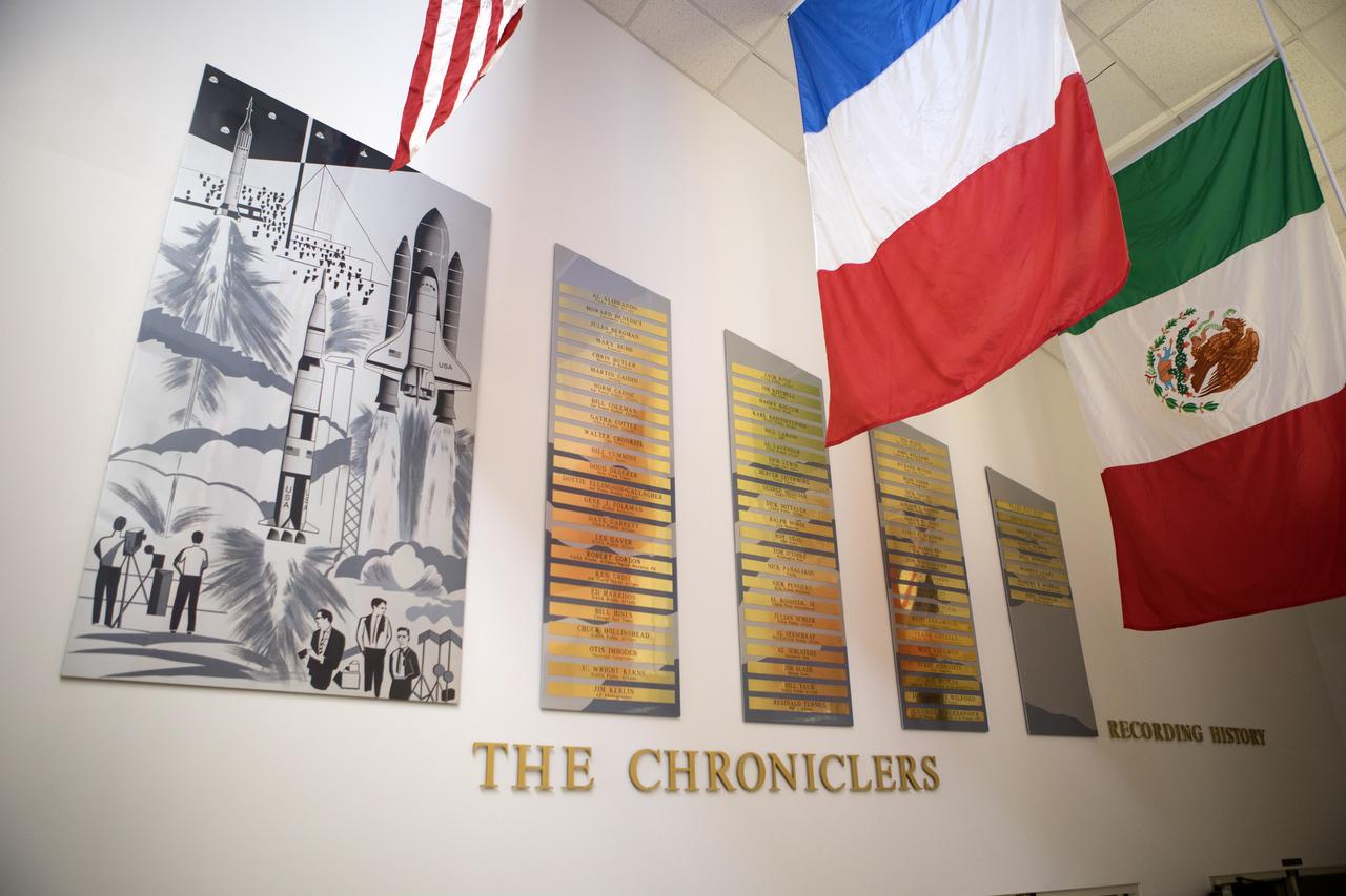 Brass plaques engraved with the names of "The Chroniclers" create a roll of honor on the wall at the NASA News Center at Kennedy Space Center in Florida. In this facility reporters from television, radio, print and online media outlets have monitored countless launches, landings and other space events in order to deliver the news to the world. The Chroniclers program recognizes retirees of the news and communications business who helped spread news of American space exploration from Kennedy Space Center for ten years or more.