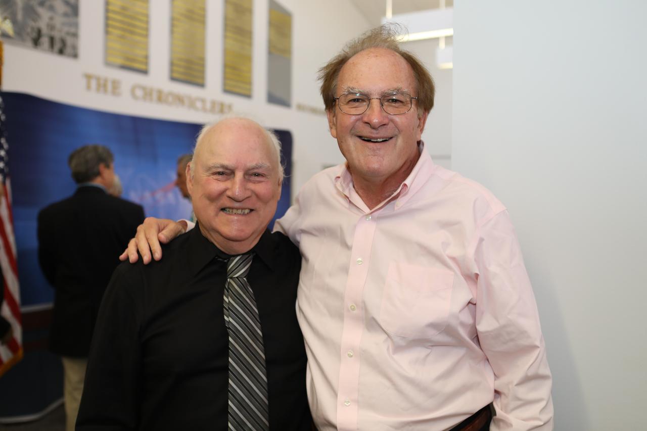 Bill Johnson, left, retired NASA chief of Media Services at Kennedy Space Center in Florida, is congratulated by NASA Public Information Specialist George Diller during a ceremony for six new honorees added to the "Chroniclers" roll of honor in the NASA News Center. Johnson, whose career at Kennedy spanned more than 45 years, was one of the six added to the Chroniclers list. Also added were Bruce Hall, CBS News and NBC News; Scott Harris, WESH, WKMG and Central Florida News 13; Warren Leary, The New York Times; Bob Murray, WDBO-TV, RCA and United Space Alliance; and Phillip Sandlin, Associated Press photographer. The Chroniclers program recognizes retirees of the news and communications business who helped spread news of American space exploration from Kennedy Space Center for ten years or more.
