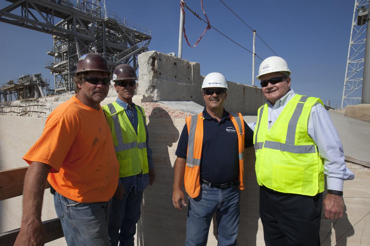 Construction workers sign the final bricks after they were installed on the north side of the flame trench at Launch Complex 39B at NASA’s Kennedy Space Center in Florida. The walls of the flame trench are being upgraded to withstand the intense heat and fire at launch of NASA's Space Launch System rocket with Orion atop. About 96,000 heat-resistant bricks, in three different sizes, were secured to the walls using bonding mortar in combination with adhesive anchors. The Ground Systems Development and Operations Program is overseeing upgrades and modifications to Pad 39B to support the launch of the SLS and Orion spacecraft for Exploration Mission-1 and NASA’s journey to Mars.