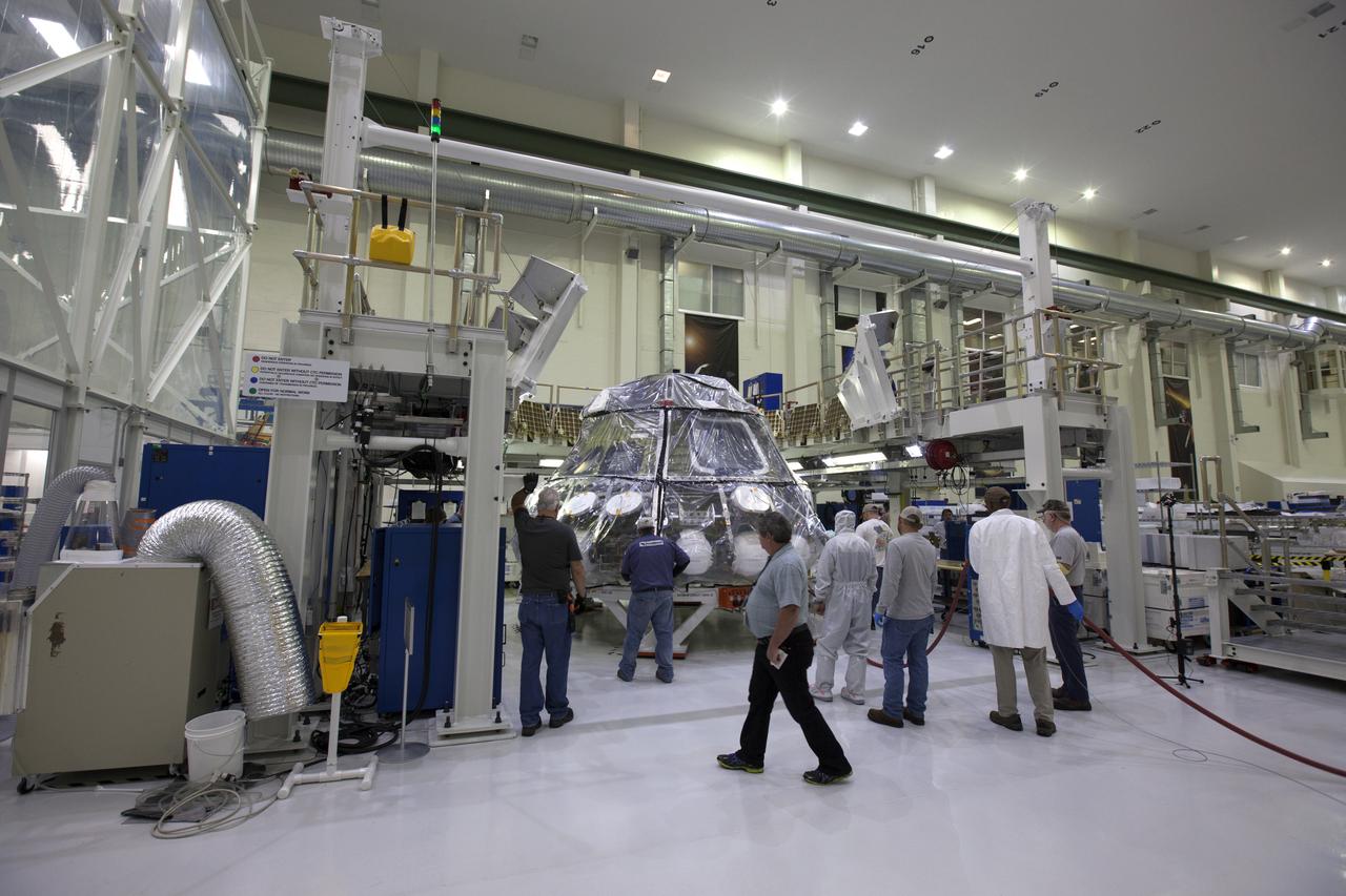 The Orion crew module for NASA’s Exploration Mission 1 (EM-1) is being secured in a work station in the Neil Armstrong Operations and Checkout Building high bay at NASA’s Kennedy Space Center in Florida. Orion will undergo additional processing to prepare it for launch in 2019. The spacecraft is being prepared for its first integrated flight atop the Space Launch System rocket on Exploration Mission-1.