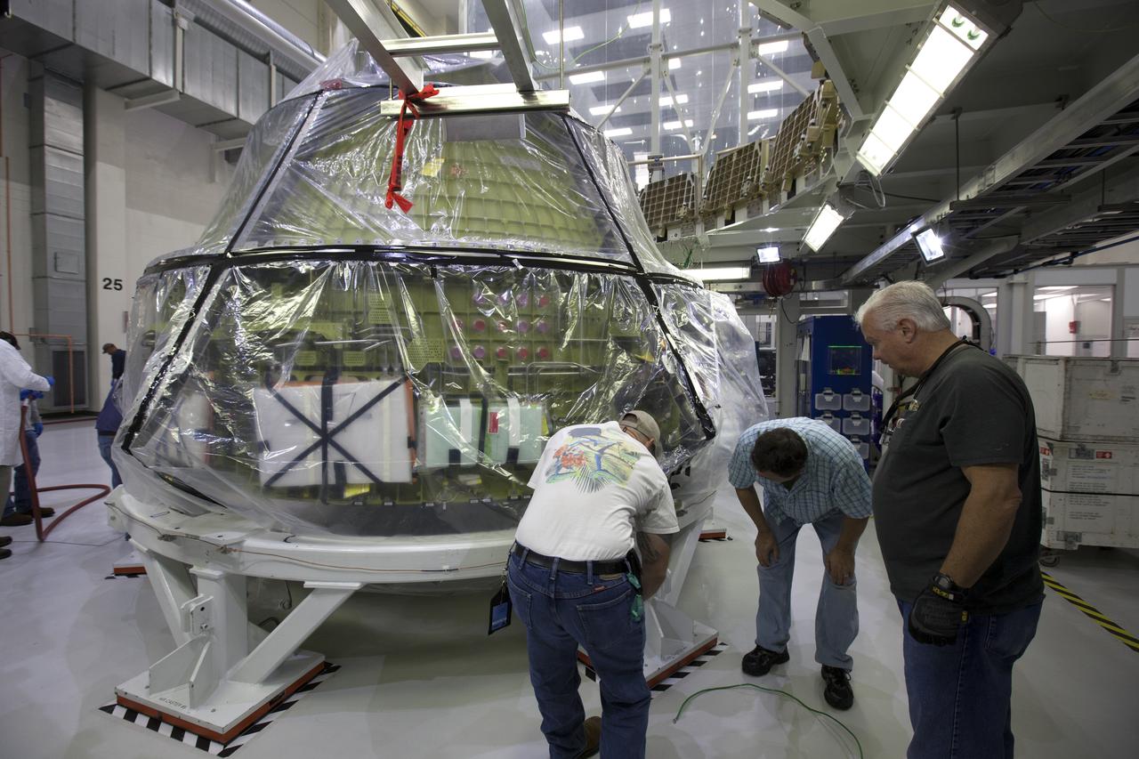 The Orion crew module for NASA’s Exploration Mission 1 (EM-1) is being secured in a work station in the Neil Armstrong Operations and Checkout Building high bay at NASA’s Kennedy Space Center in Florida. Orion will undergo additional processing to prepare it for launch in 2019. The spacecraft is being prepared for its first integrated flight atop the Space Launch System rocket on Exploration Mission-1.