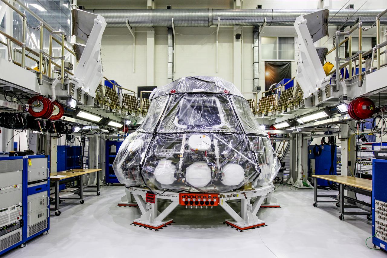 The Orion crew module for NASA’s Exploration Mission 1 (EM-1) is secured in a work station in the Neil Armstrong Operations and Checkout Building high bay at NASA’s Kennedy Space Center in Florida. Orion will undergo additional processing to prepare it for launch in 2019. The spacecraft is being prepared for its first integrated flight atop the Space Launch System rocket on Exploration Mission-1. 