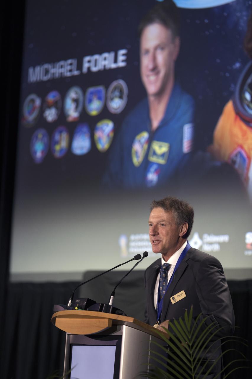 Michael Foale, who flew six missions into space, speaks during the U.S. Astronaut Hall of Fame ceremony. The ceremony took place in the Space Shuttle Atlantis facility at the Kennedy Space Center Visitor Complex in Florida.
