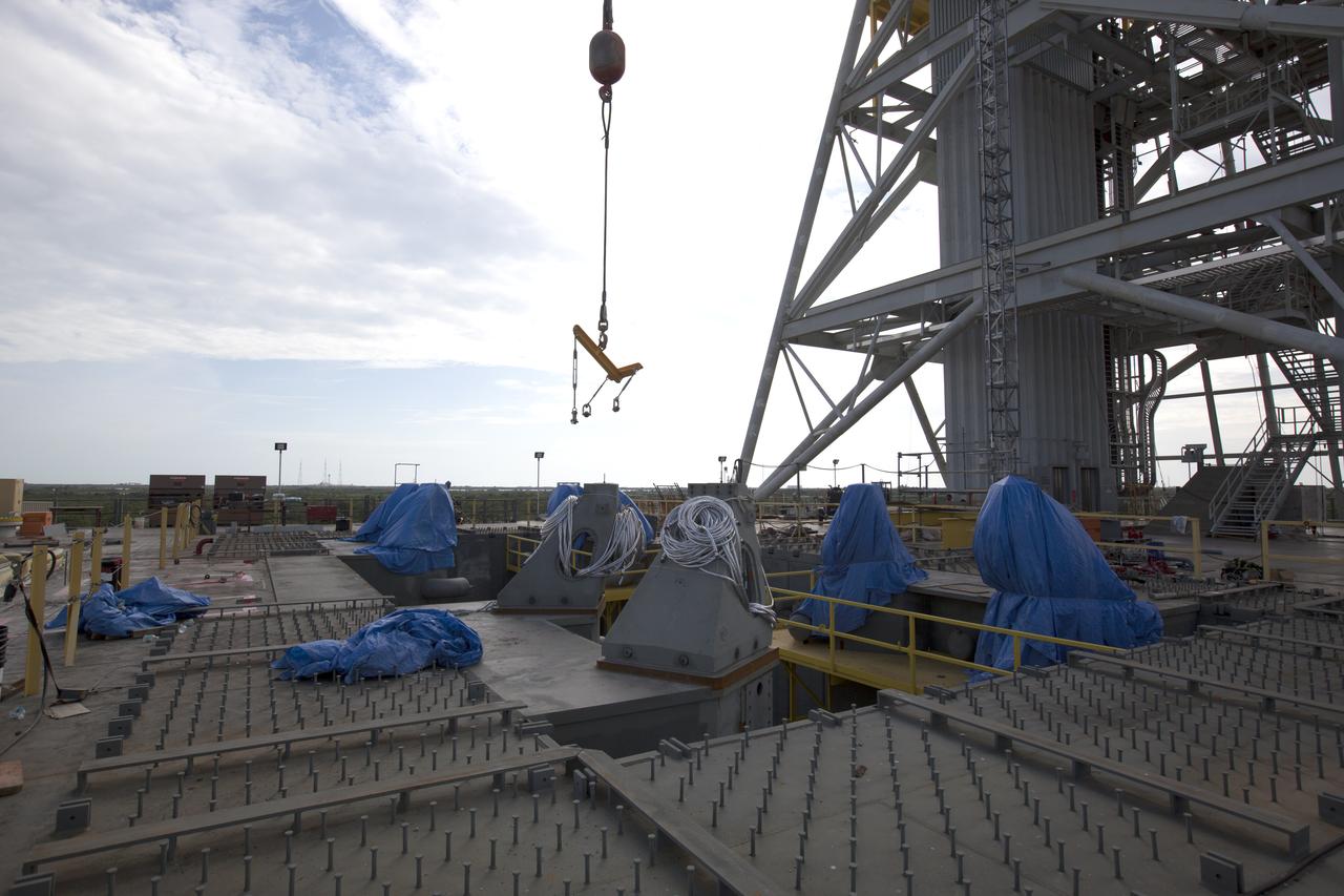 At NASA's Kennedy Space Center in Florida, the final four vehicle support posts are being installed on the deck of the mobile launcher. A total of eight support posts are being installed to support the load of the Space Launch System's (SLS) solid rocket boosters, with four posts for each of the boosters. The support posts are about five feet tall and each weigh about 10,000 pounds. The posts will structurally support the SLS rocket through T-0 and liftoff, and will drop down before vehicle liftoff to avoid contact with the flight hardware. The Ground Systems Development and Operations Program is overseeing installation of the support posts to prepare for the launch of the Orion spacecraft atop the SLS rocket.
