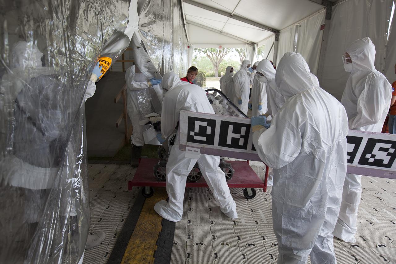 College team members prepare to enter the robotic mining arena for a test run during NASA's 8th Annual Robotic Mining Competition at the Kennedy Space Center Visitor Complex in Florida. More than 40 student teams from colleges and universities around the U.S. will use their uniquely-designed mining robots to dig in a supersized sandbox filled with BP-1, or simulated Martian soil, and participate in other competition requirements. The Robotic Mining Competition is a NASA Human Exploration and Operations Mission Directorate project designed to encourage students in science, technology, engineering and math, or STEM fields. The project provides a competitive environment to foster innovative ideas and solutions that could be used on NASA's Journey to Mars.