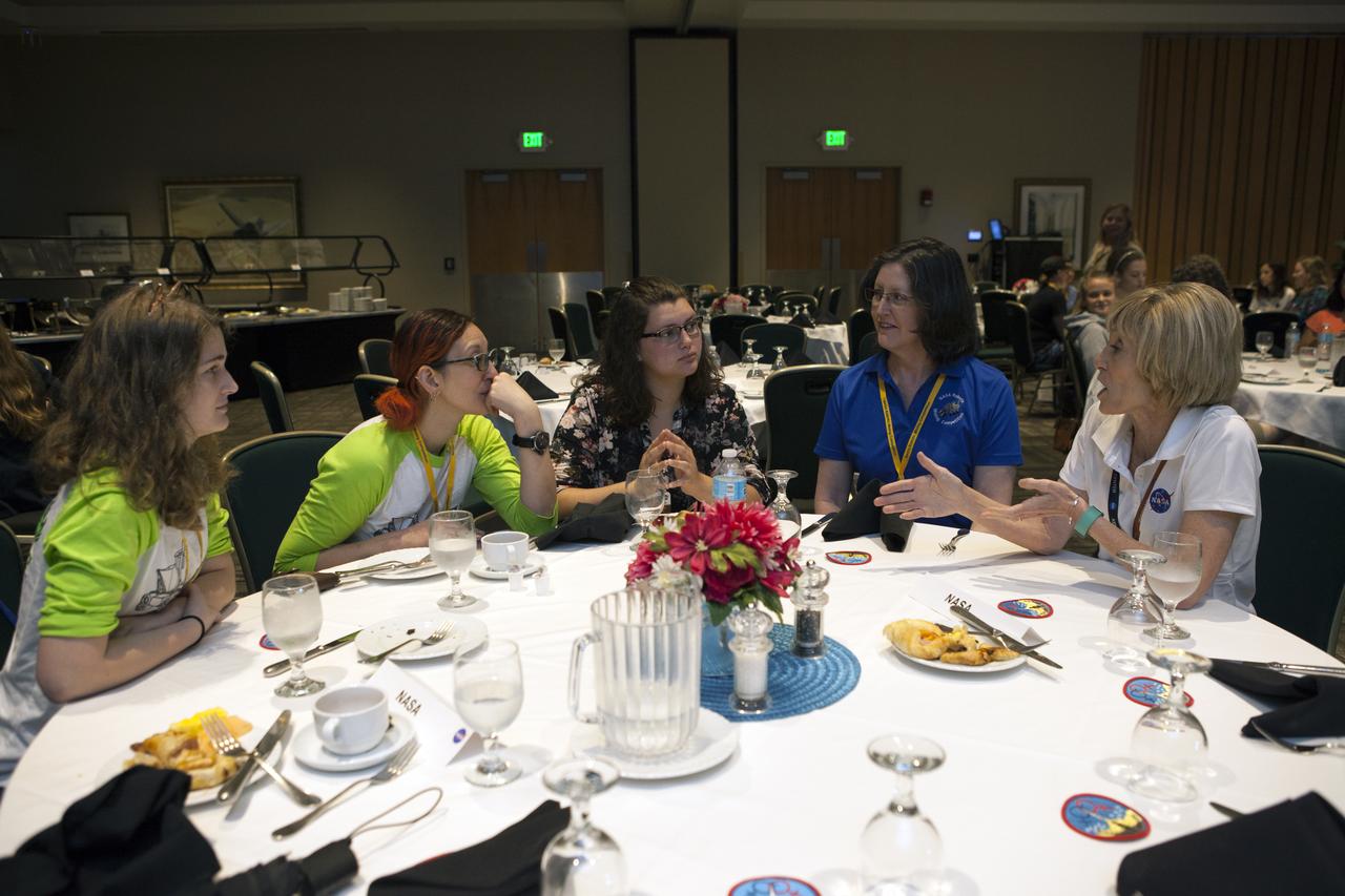 Jonette Stecklein (in the blue shirt), a flight systems engineer from Johnson Space Center in Houston, talks to students during a Women in STEM mentoring breakfast inside the Debus Conference Center at the Kennedy Space Center Visitor Complex in Florida. STEM is science, technology, engineering and math. The special event gave students competing in NASA's 8th Annual Robotic Mining Competition the chance to learn from female NASA scientists, engineers and professionals about their careers and the paths they took to working at Kennedy. The Robotic Mining Competition is a NASA Human Exploration and Operations Mission Directorate project designed to encourage students in STEM fields. The project provides a competitive environment to foster innovative ideas and solutions that could be used on NASA's Journey to Mars.