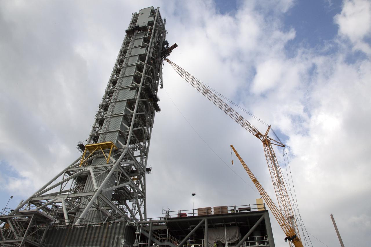 Cranes and rigging are being used to lift up the Core Stage Forward Skirt Umbilical (CSFSU) for installation on the mobile launcher tower at NASA's Kennedy Space Center in Florida. The mobile launcher tower will be equipped with a number of lines, called umbilicals that will connect to the Space Launch System (SLS) rocket and Orion spacecraft for Exploration Mission-1 (EM-1). The CSFSU will be located at about the 180-foot level on the tower, above the liquid oxygen tank. The CSFSU is an umbilical that will swing into position to provide connections to the core stage forward skirt of the SLS rocket, and then swing away before launch. Its main purpose is to provide conditioned air/GN2 to the SLS core stage forward skirt cavity. The Ground Systems Development and Operations Program is overseeing installation of the umbilicals. 