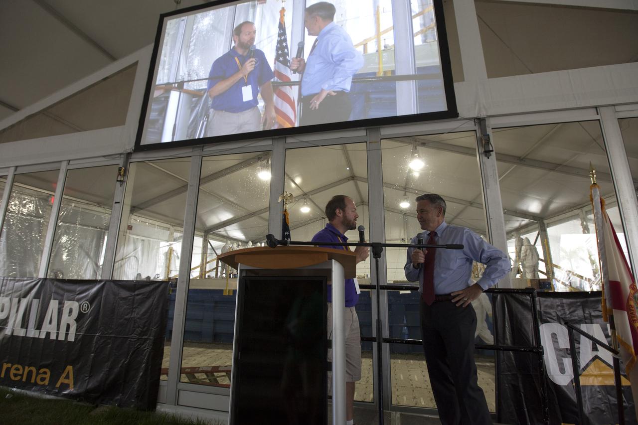 NASA Kennedy Space Center Director Bob Cabana, at right, talks with Kurt Leucht, event emcee, during media day at the agency's 8th Annual Robotic Mining Competition at the Kennedy Space Center Visitor Complex in Florida. At the mining arena, Cabana shared his thoughts about the competition and the progress made to make Kennedy a multi-user spaceport. Teams from colleges and universities around the U.S. used their mining robots to dig in a supersized sandbox filled with BP-1, or simulated Martian soil, and participated in other competition requirements, May 22-26. The Robotic Mining Competition is a NASA Human Exploration and Operations Mission Directorate project designed to encourage students in science, technology, engineering and math, or STEM fields. The project provides a competitive environment to foster innovative ideas and solutions that could be used on NASA's Journey to Mars.
