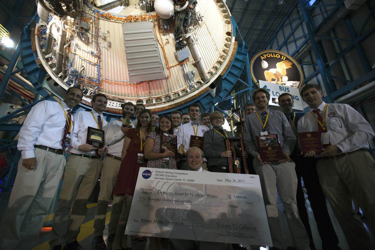 Team Astrobotics from The University of Alabama won the top award, the Joe Kosmo Award for Excellence, and several other awards, during NASA's 8th Annual Robotic Competition award ceremony inside the Apollo-Saturn V Center at the Kennedy Space Center Visitor Complex in Florida. More than 40 student teams from colleges and universities around the U.S. used their uniquely-designed mining robots to dig in a supersized sandbox filled with BP-1, or simulated Martian soil, and participated in other competition requirements, May 22-26, at the visitor complex. The Robotic Mining Competition is a NASA Human Exploration and Operations Mission Directorate project designed to encourage students in science, technology, engineering and math, or STEM fields. The project provides a competitive environment to foster innovative ideas and solutions that could be used on NASA's Journey to Mars. 