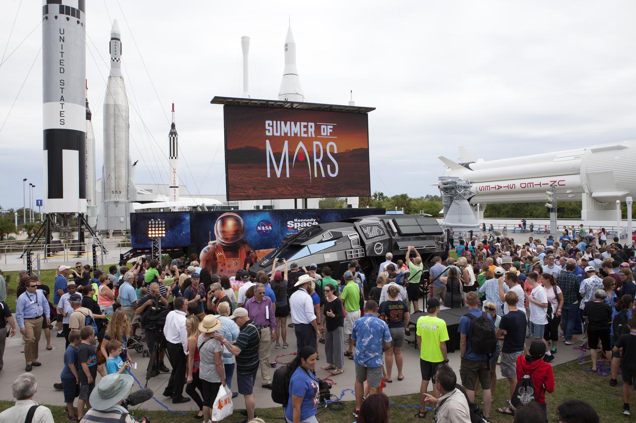 Crowds gather around the scientifically-themed Mars rover concept vehicle at the Kennedy Space Center Visitor Complex. It is a part of the "Summer of Mars" program designed to provide a survey of NASA's studies of the Red Planet. The builders of the rover, Parker Brothers Concepts of Port Canaveral, Florida, incorporated input into its design from NASA subject matter experts.