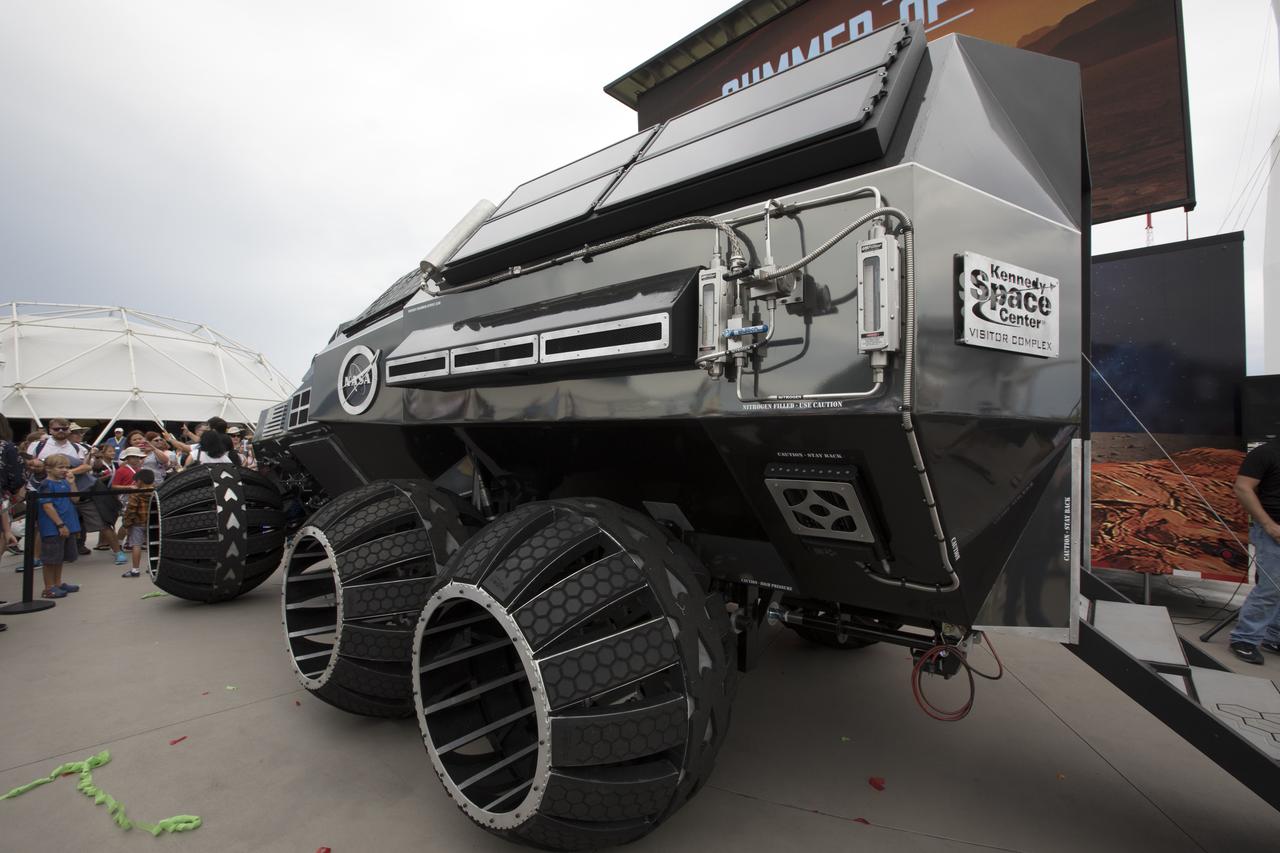 The scientifically-themed Mars rover concept vehicle operates on an electric motor, powered by solar panels and a 700-volt battery. The back section opens and serves as a laboratory which can disconnect for autonomous research. While this exact rover is not expected to operate on Mars, one or more of its elements could make its way into a rover astronauts will drive on the Red Planet. The "Summer of Mars" promotion is designed to provide guests with a better understanding of NASA's studies of the Red Planet. The builders of the rover, Parker Brothers Concepts of Port Canaveral, Florida, incorporated input into its design from NASA subject matter experts.