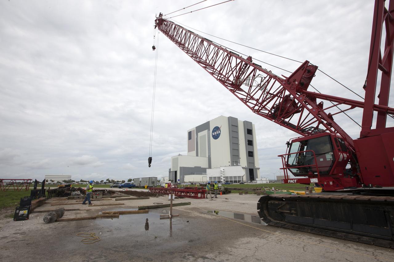 Modifications are underway at the Launch Complex 39 turn basin wharf at NASA's Kennedy Space Center in Florida to prepare for the arrival of the agency's massive Space Launch System (SLS) core stage aboard the barge Pegasus. A crane will be used to lift up precast concrete poles and position them to be driven to a depth of about 70 feet into the bedrock below the water around the turn basin. The upgrades are necessary to accommodate the increased weight of the core stage along with ground support and transportation equipment aboard the modified barge Pegasus. The Ground Systems Development and Operations Program is overseeing the upgrades to the turn basin wharf.