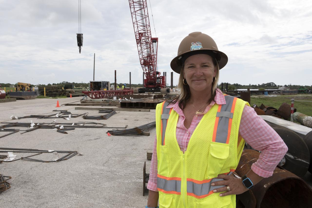 Modifications are underway at the Launch Complex 39 turn basin wharf at NASA's Kennedy Space Center in Florida to prepare for the arrival of the agency's massive Space Launch System (SLS) core stage aboard the barge Pegasus. In the foreground is Tammy Kelly, site manager, with Southeast Cherokee Construction Inc. A crane will be used to lift up precast concrete poles and position them to be driven to a depth of about 70 feet into the bedrock below the water around the turn basin. The upgrades are necessary to accommodate the increased weight of the core stage along with ground support and transportation equipment aboard the modified barge Pegasus. The Ground Systems Development and Operations Program is overseeing the upgrades to the turn basin wharf. 