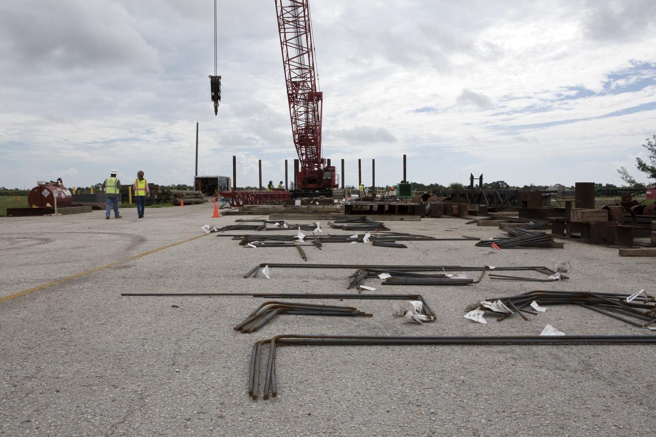 Modifications are underway at the Launch Complex 39 turn basin wharf at NASA's Kennedy Space Center in Florida to prepare for the arrival of the agency's massive Space Launch System (SLS) core stage aboard the barge Pegasus. A crane will be used to lift up precast concrete poles and position them to be driven to a depth of about 70 feet into the bedrock below the water around the turn basin. The upgrades are necessary to accommodate the 300,000-pound core booster aboard the modified Pegasus barge. The Ground Systems Development and Operations Program is overseeing the upgrades to the turn basin wharf. 