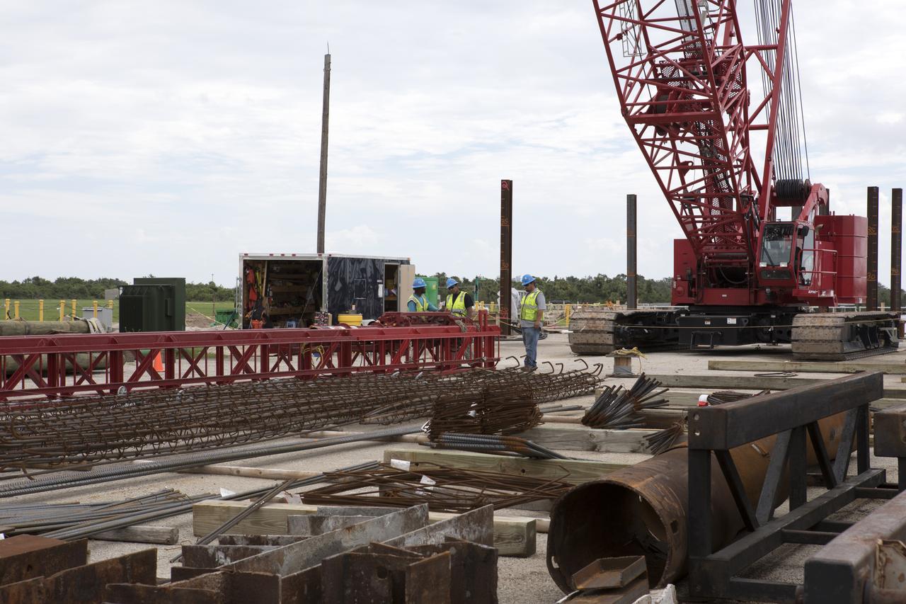 Modifications are underway at the Launch Complex 39 turn basin wharf at NASA's Kennedy Space Center in Florida to prepare for the arrival of the agency's massive Space Launch System (SLS) core stage aboard the barge Pegasus. Equipment is staged and a crane will be used to lift up precast concrete poles and position them to be driven to a depth of about 70 feet into the bedrock below the water around the turn basin. The upgrades are necessary to accommodate the increased weight of the core stage along with ground support and transportation equipment aboard the modified barge Pegasus. The Ground Systems Development and Operations Program is overseeing the upgrades to the turn basin wharf. 