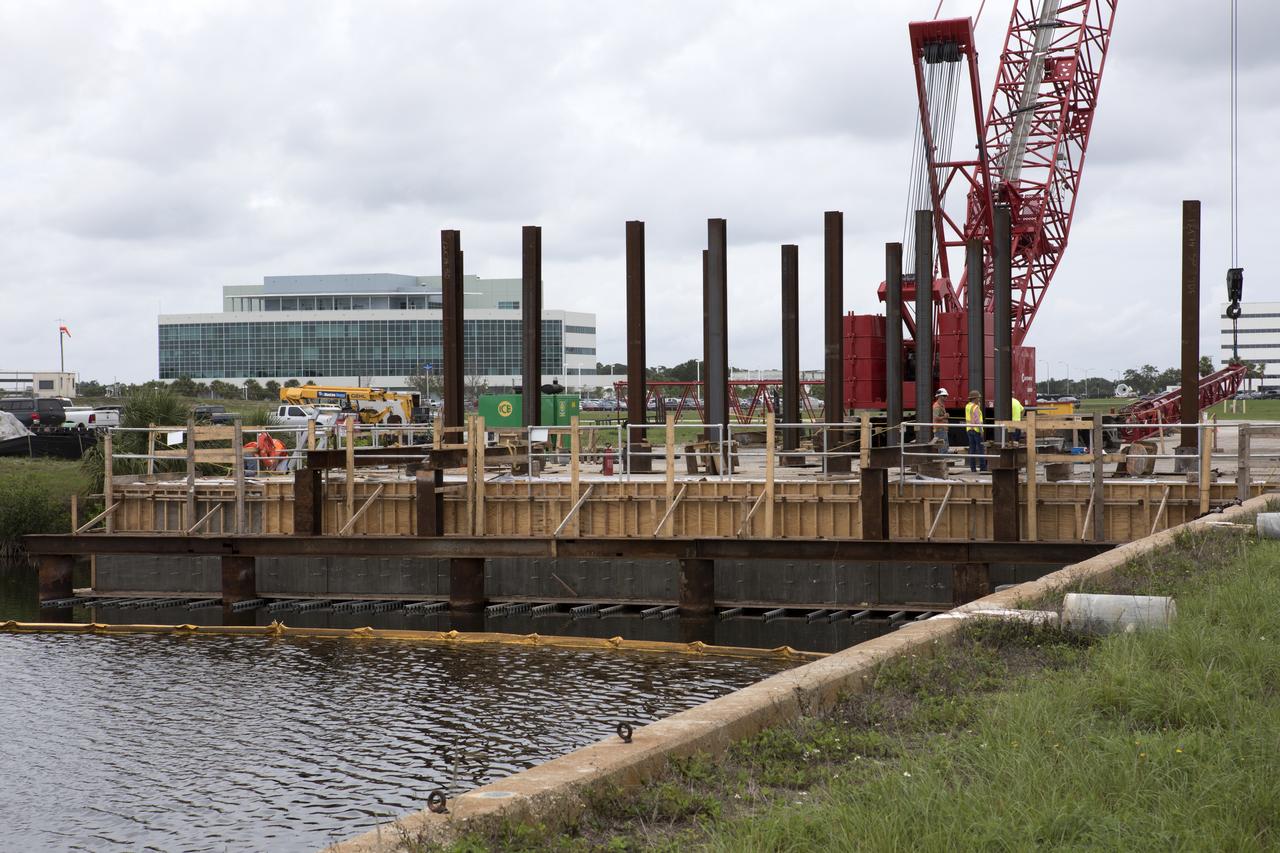 Modifications are underway at the Launch Complex 39 turn basin wharf at NASA's Kennedy Space Center in Florida to prepare for the arrival of the agency's massive Space Launch System (SLS) core stage aboard the barge Pegasus. Precast concrete poles are being driven to a depth of about 70 feet into the bedrock below the water around the turn basin. The upgrades are necessary to accommodate the increased weight of the core stage along with ground support and transportation equipment aboard the modified barge Pegasus. The Ground Systems Development and Operations Program is overseeing the upgrades to the turn basin wharf.