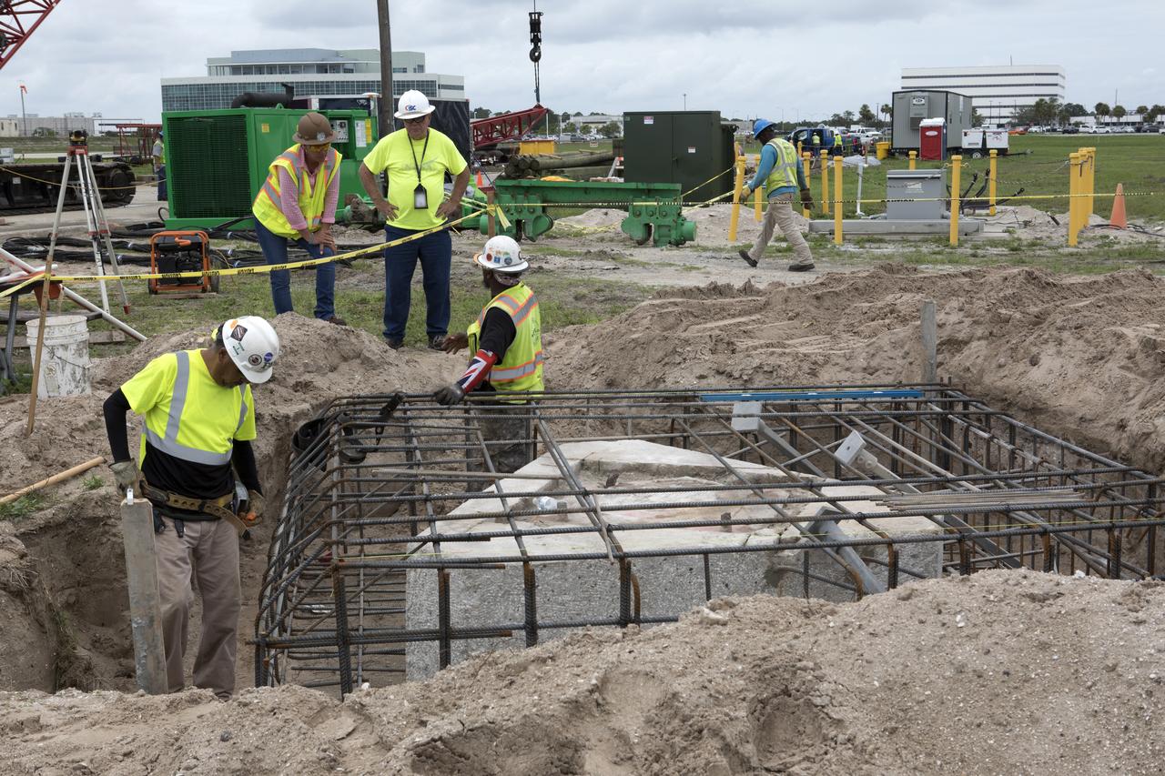 Modifications are underway at the Launch Complex 39 turn basin wharf at NASA's Kennedy Space Center in Florida to prepare for the arrival of the agency's massive Space Launch System (SLS) core booster aboard the barge Pegasus. Construction workers with Southeast Cherokee Construction Inc. work to shore up the turn basin area. A crane will be used to lift up precast concrete poles and position them to be driven to a depth of about 70 feet into the bedrock below the water around the turn basin. The upgrades are necessary to accommodate the 300,000-pound core booster aboard the modified Pegasus barge. The Ground Systems Development and Operations Program is overseeing the upgrades to the turn basin wharf. 