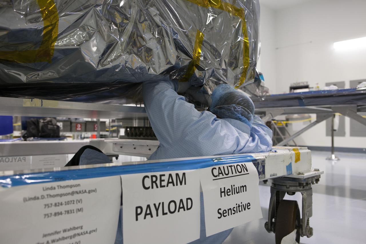 In the Space Station Processing Facility at NASA's Kennedy Space Center in Florida, a technician remove a protective cover on the Cosmic-Ray Energetics and Mass investigation, or CREAM, instrument. It is designed to measure the charges of cosmic rays to better understand what gives them such incredible energies, and how that effects the composition of the universe. The instrument will be launched to the space station on the SpaceX CRS-12 commercial resupply mission in August 2017.