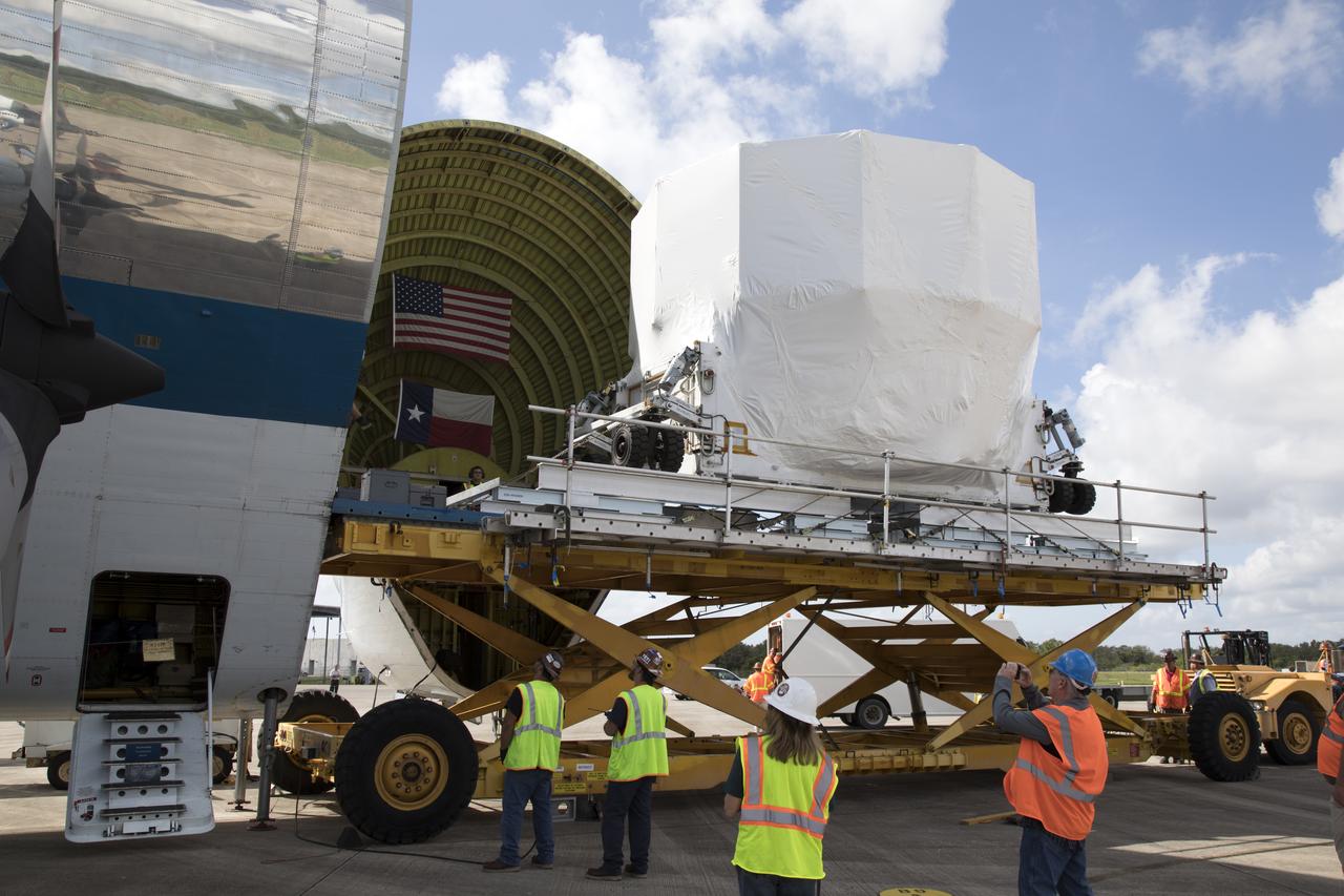 At Kennedy Space Center's Shuttle Landing Facility in Florida, workers prepare to move the Orion service module structural test article for Exploration Mission-1 (EM-1), built by the European Space Agency, inside NASA's Super Guppy aircraft. The module will be secured inside the aircraft and shipped to Lockheed Martin's Denver facility to undergo testing. The Orion spacecraft will launch atop the agency's Space Launch System rocket on EM-1 in 2019.