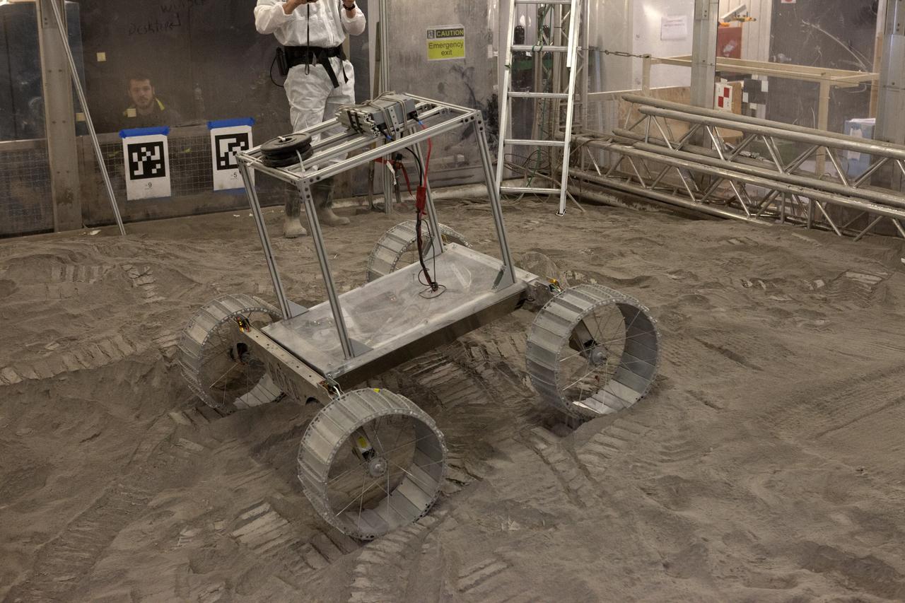 A lightweight simulator version of NASA's Resource Prospector undergoes a mobility test in a regolith bin at the agency's Kennedy Space center in Florida. The Resource Prospector mission aims to be the first mining expedition on another world. Operating on the moon’s poles, the robot is designed to use instruments to locate elements at a lunar polar regions, then excavate and sample resources such as hydrogen, oxygen and water. These resources could support human explores on their way to destinations such as farther into the solar system.