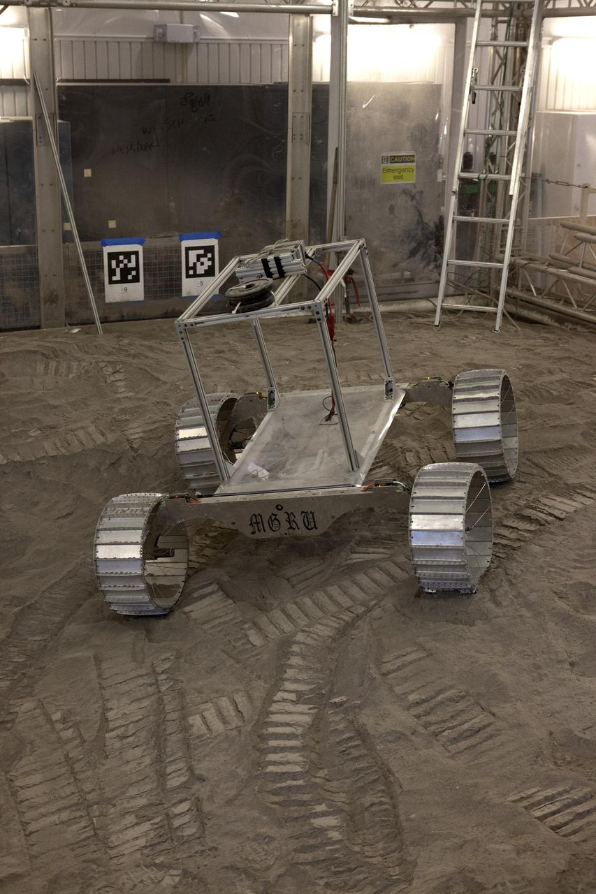 A lightweight simulator version of NASA's Resource Prospector undergoes a mobility test in a regolith bin at the agency's Kennedy Space center in Florida. The Resource Prospector mission aims to be the first mining expedition on another world. Operating on the moon’s poles, the robot is designed to use instruments to locate elements at a lunar polar regions, then excavate and sample resources such as hydrogen, oxygen and water. These resources could support human explores on their way to destinations such as farther into the solar system.