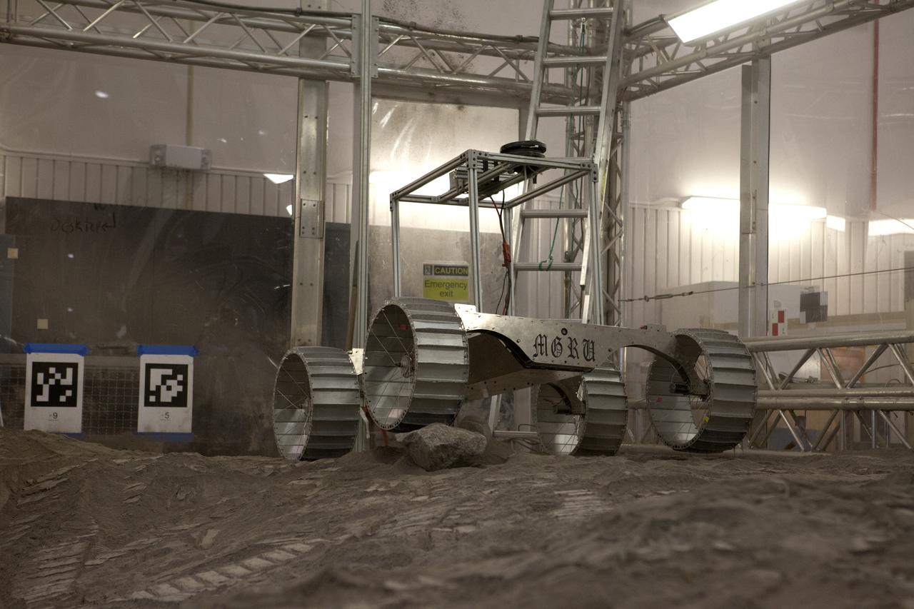 A lightweight simulator version of NASA's Resource Prospector undergoes a mobility test in a regolith bin at the agency's Kennedy Space center in Florida. The Resource Prospector mission aims to be the first mining expedition on another world. Operating on the moon’s poles, the robot is designed to use instruments to locate elements at a lunar polar regions, then excavate and sample resources such as hydrogen, oxygen and water. These resources could support human explores on their way to destinations such as farther into the solar system.