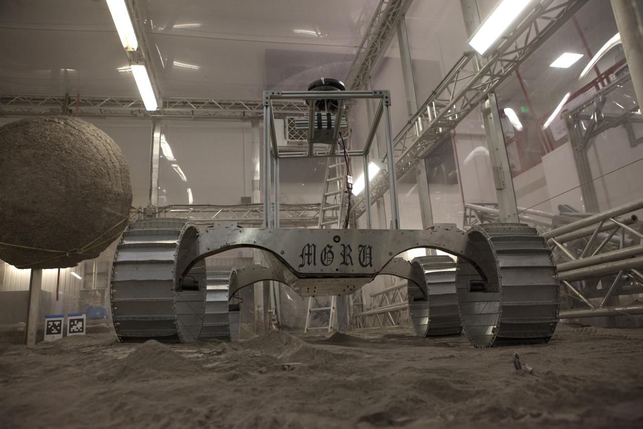 A lightweight simulator version of NASA's Resource Prospector undergoes a mobility test in a regolith bin at the agency's Kennedy Space center in Florida. The Resource Prospector mission aims to be the first mining expedition on another world. Operating on the moon’s poles, the robot is designed to use instruments to locate elements at a lunar polar regions, then excavate and sample resources such as hydrogen, oxygen and water. These resources could support human explores on their way to destinations such as farther into the solar system.