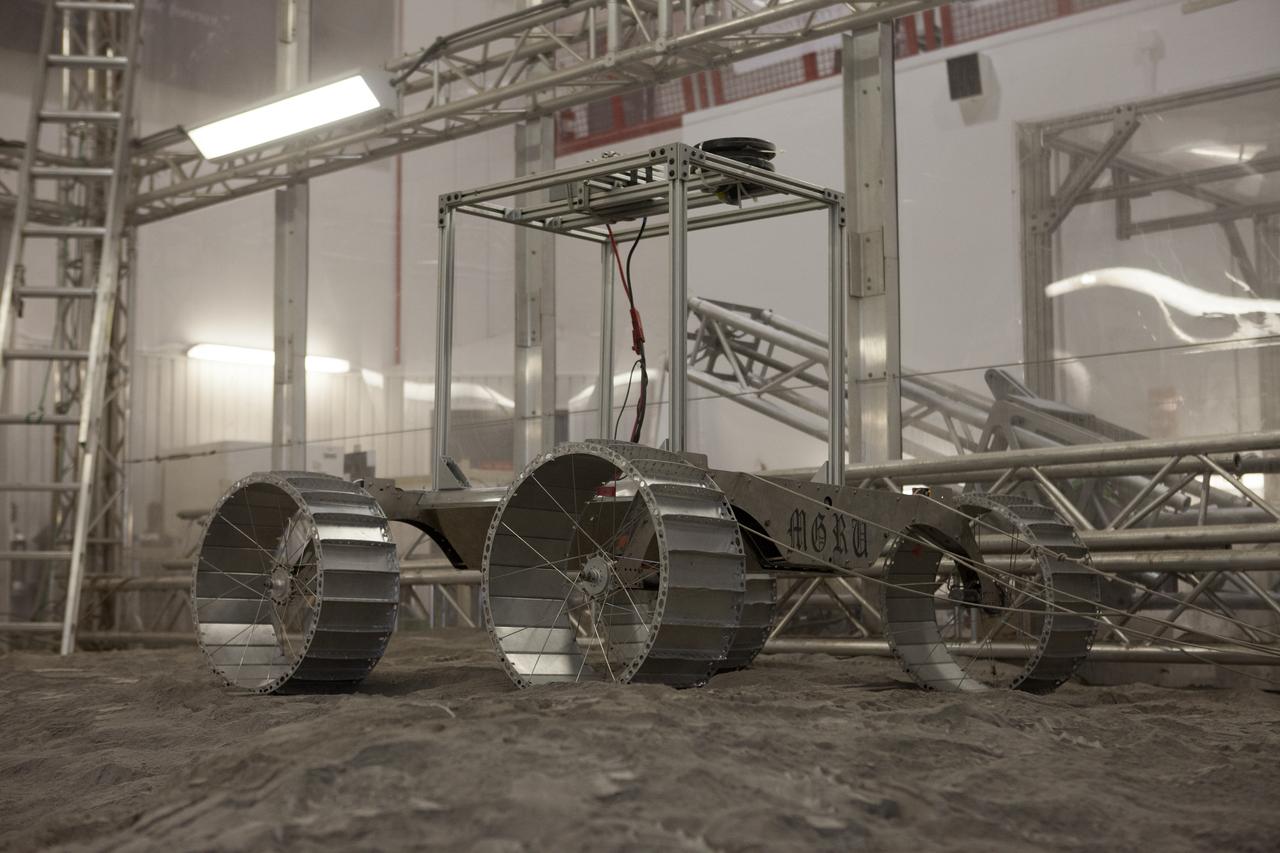 A lightweight simulator version of NASA's Resource Prospector undergoes a mobility test in a regolith bin at the agency's Kennedy Space center in Florida. The Resource Prospector mission aims to be the first mining expedition on another world. Operating on the moon’s poles, the robot is designed to use instruments to locate elements at a lunar polar regions, then excavate and sample resources such as hydrogen, oxygen and water. These resources could support human explores on their way to destinations such as farther into the solar system.