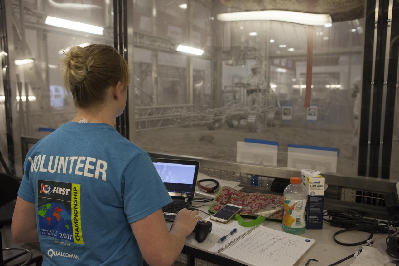 Outside a regolith bin at the agency's Kennedy Space center in Florida, an engineer operates controls for a lightweight simulator version of NASA's Resource Prospector during a mobility test. The Resource Prospector mission aims to be the first mining expedition on another world. Operating on the moon’s poles, the robot is designed to use instruments to locate elements at a lunar polar regions, then excavate and sample resources such as hydrogen, oxygen and water. These resources could support human explores on their way to destinations such as farther into the solar system.