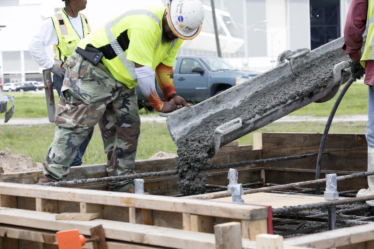 At NASA's Kennedy Space Center in Florida, cement is poured as part of a construction project to upgrade the turn basin wharf. The work includes driving multiple precast concrete piles to a depth of about 70 feet to accommodate arrival of the core stage for the agency's Space Launch System (SLS) rocket. When the stage for NASA's SLS departs the Michoud Assembly Facility in New Orleans, it will be shipped by the agency's modified barge to the Launch Complex 39 turn basin.