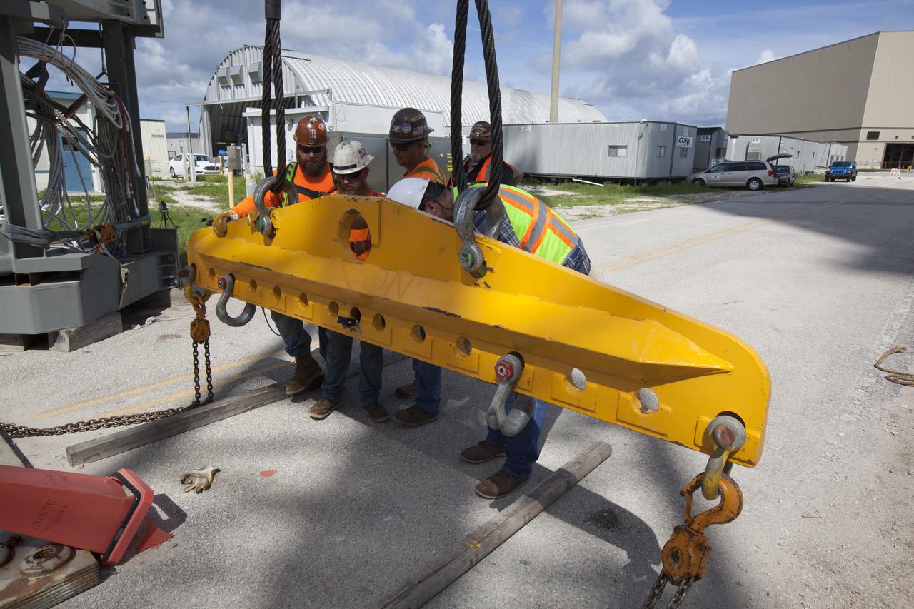 Just north of the Vehicle Assembly Building at NASA's Kennedy Space Center in Florida, technicians prepare a crane to lift the core stage forward skirt umbilical (CSFSU) for installation onto the mobile launcher. The mobile launcher is designed to support the assembly, testing and check-out of the agency's Space Launch System (SLS) rocket and the Orion spacecraft.
