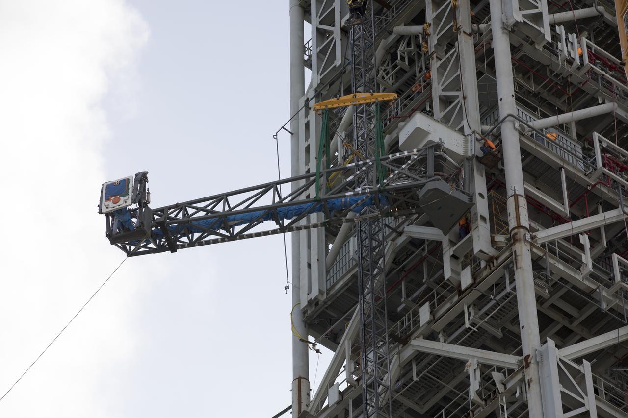 Just north of the Vehicle Assembly Building at NASA's Kennedy Space Center in Florida, the core stage forward skirt umbilical is installed on the mobile launcher. The mobile launcher is designed to support the assembly, testing and check-out of the agency's Space Launch System (SLS) rocket and the Orion spacecraft.