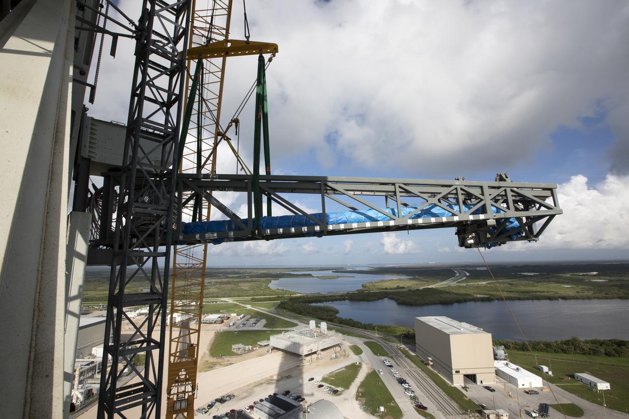 Just north of the Vehicle Assembly Building at NASA's Kennedy Space Center in Florida, the core stage forward skirt umbilical is installed on the mobile launcher. The mobile launcher is designed to support the assembly, testing and check-out of the agency's Space Launch System (SLS) rocket and the Orion spacecraft.