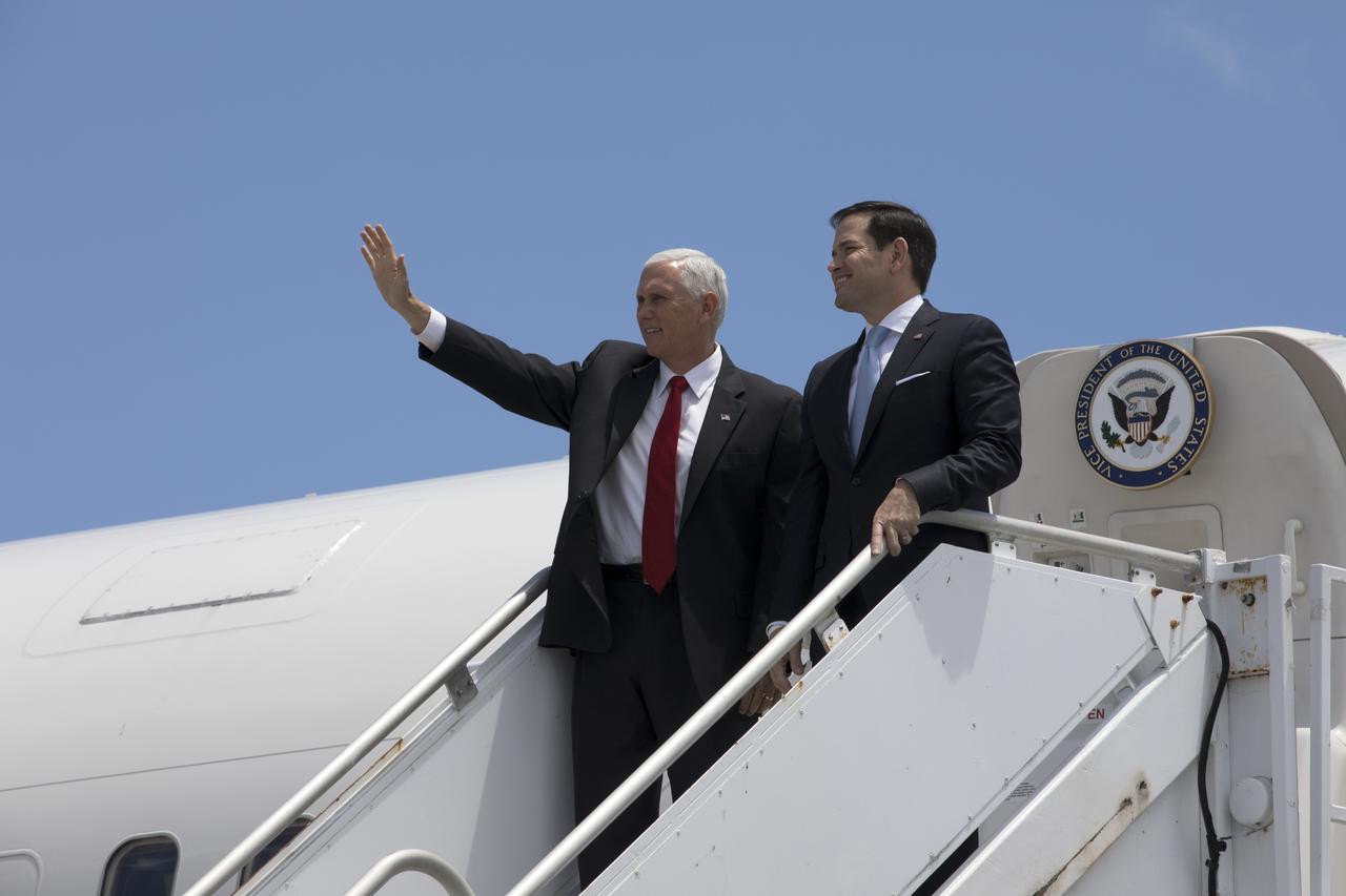 Vice President Mike Pence, left, waves as he and Sen. Marco Rubio of Florida arrive aboard Air Force Two at the Shuttle Landing Facility at NASA's Kennedy Space Center in Florida. During his visit to Kennedy, the Vice President spoke inside the iconic Vehicle Assembly Building, where he thanked employees for advancing American leadership in space. 