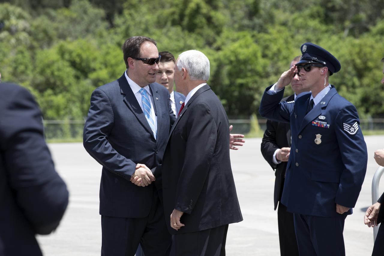 NASA's Acting Administrator Robert Lightfoot, left, greets Vide President Mike Pence at the Shuttle Landing Facility at the agency's Kennedy Space Center in Florida. During his visit to Kennedy, the Vice President spoke inside the iconic Vehicle Assembly Building, where he thanked employees for advancing American leadership in space. 