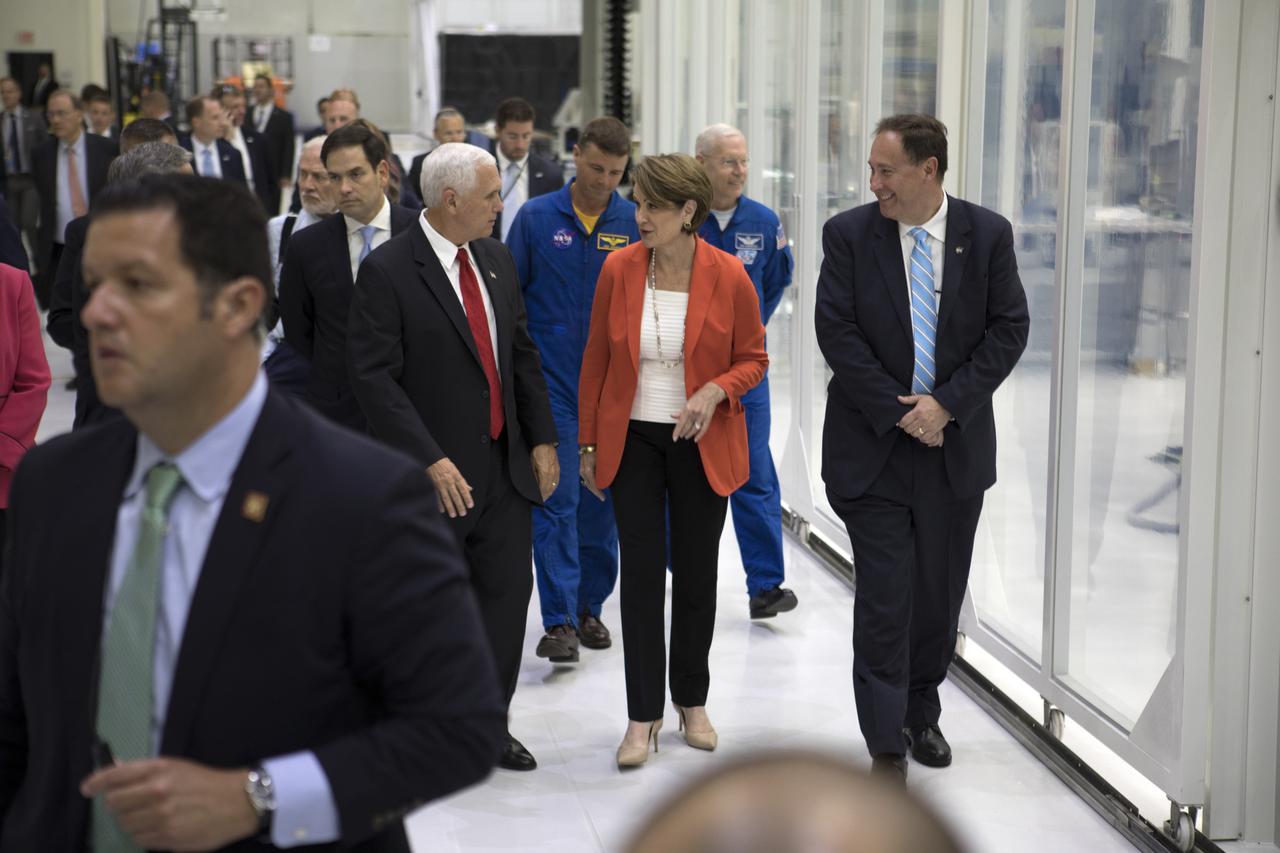 Vice President Mike Pence, center left, listens to Lockheed Martin Chairman, President and CEO Marillyn Hewson during a tour of the Neil Armstrong Operations and Checkout Building at NASA's Kennedy Space Center in Florida, where the Orion spacecraft is being readied for a trip beyond the moon on its first integrated flight with the Space Launch System rocket. Walking with them from left to right are U.S. Senator Marco Rubio (R-FL), NASA Astronauts Reid Wiseman and Pat Forrester, and NASA Acting Administrator Robert Lightfoot. During his visit to Kennedy, Pence spoke inside the Vehicle Assembly Building, where he thanked employees for advancing American leadership in space. The Vice President also toured several facilities highlighting the public-private partnerships at Kennedy, as both NASA and commercial companies prepare to launch American astronauts from the multi-user spaceport.