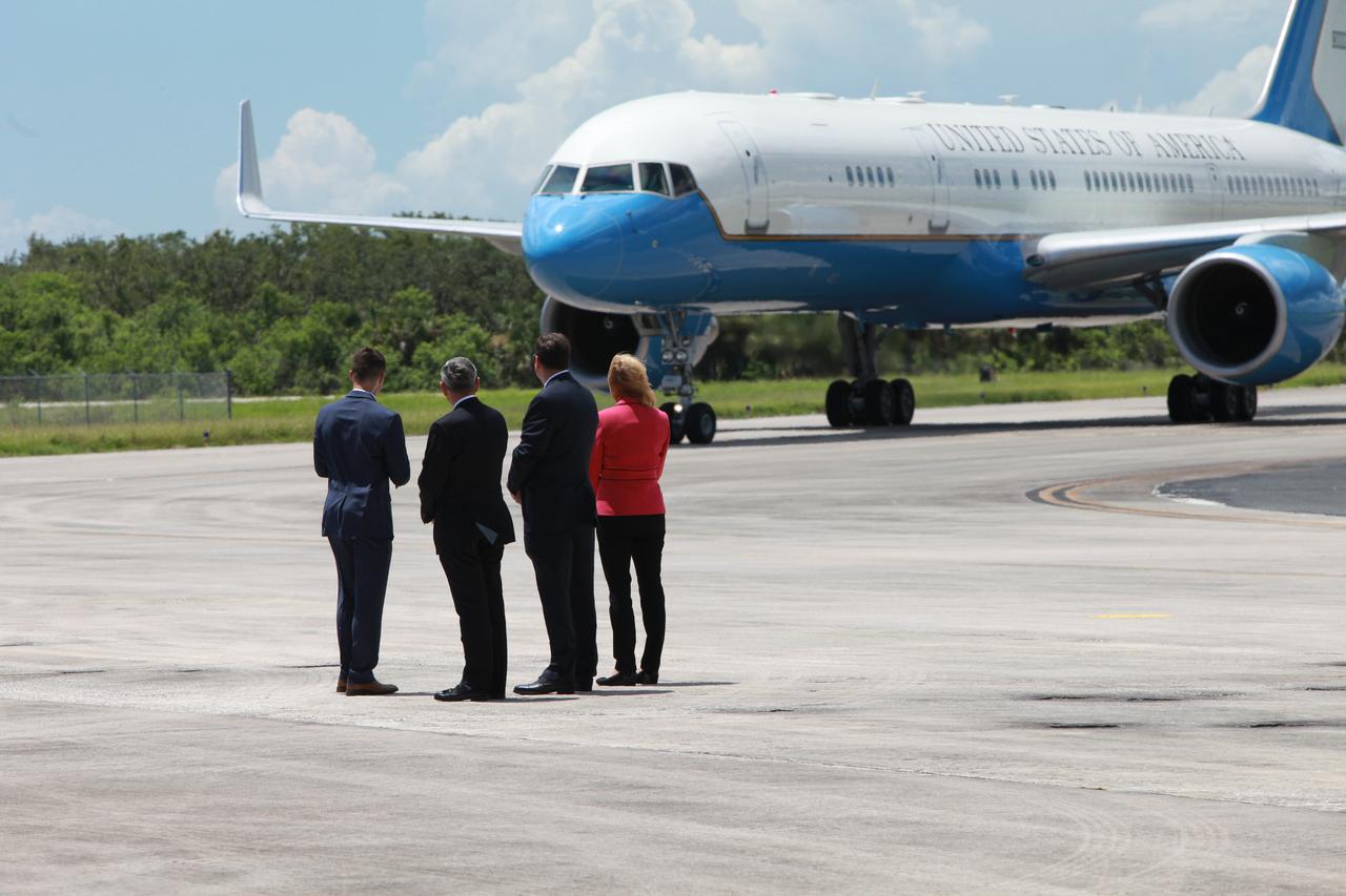 Accompanied by a White House staffer, left, NASA Kennedy Space Center Director Robert Cabana, Acting NASA Administrator Robert Lightfoot and Kennedy Space Center Deputy Director Janet Petro watch as Air Force Two, carrying Vice President Mike Pence, approaches on the Shuttle Landing Facility at NASA's Kennedy Space Center in Florida. During his visit to Kennedy, Pence spoke inside the iconic Vehicle Assembly Building, where he thanked employees for advancing American leadership in space.