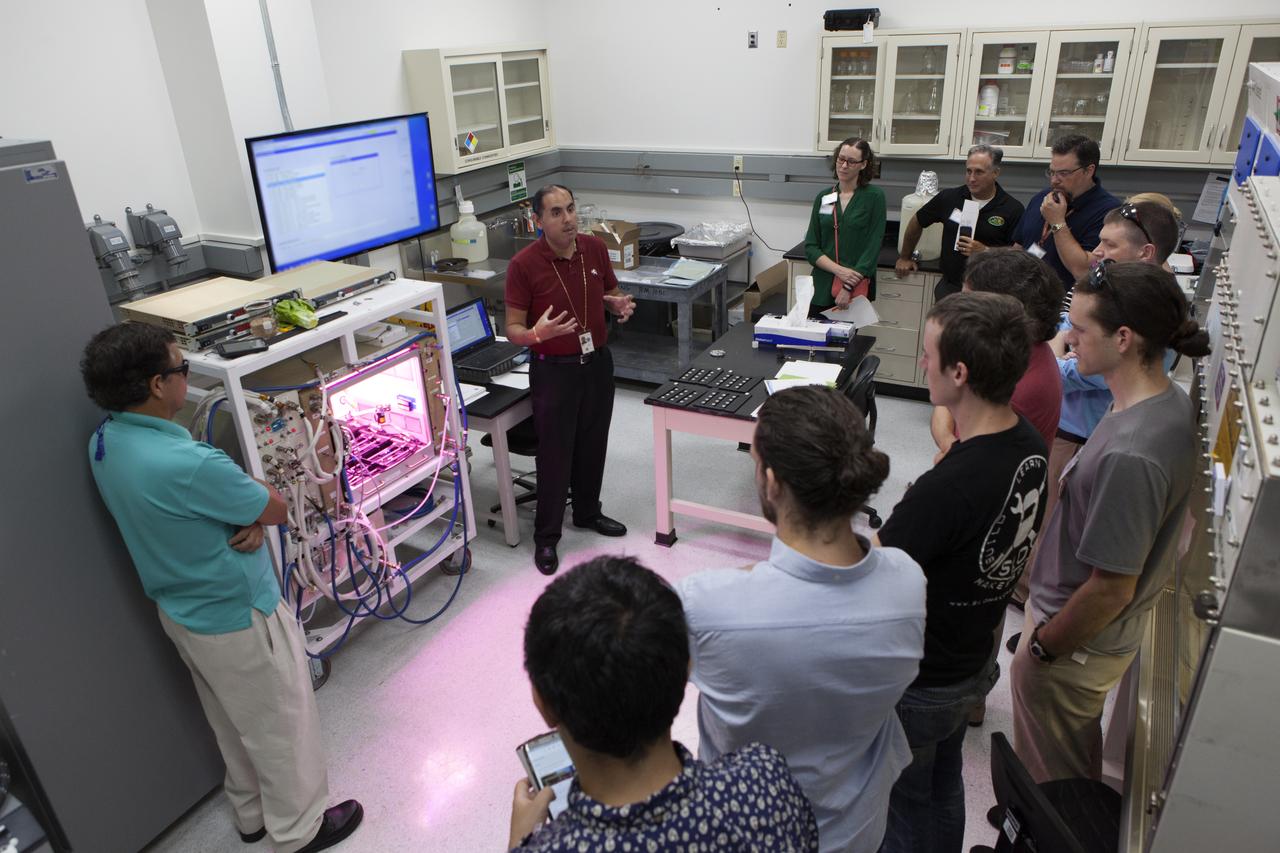 Bryan Onate, Advanced Plant Habitat project manager, with the Exploration Research and Technology Directorate, brainstorms innovative approaches to food production with industry representatives inside a laboratory at the Space Station Processing Facility at NASA's Kennedy Space Center in Florida. 