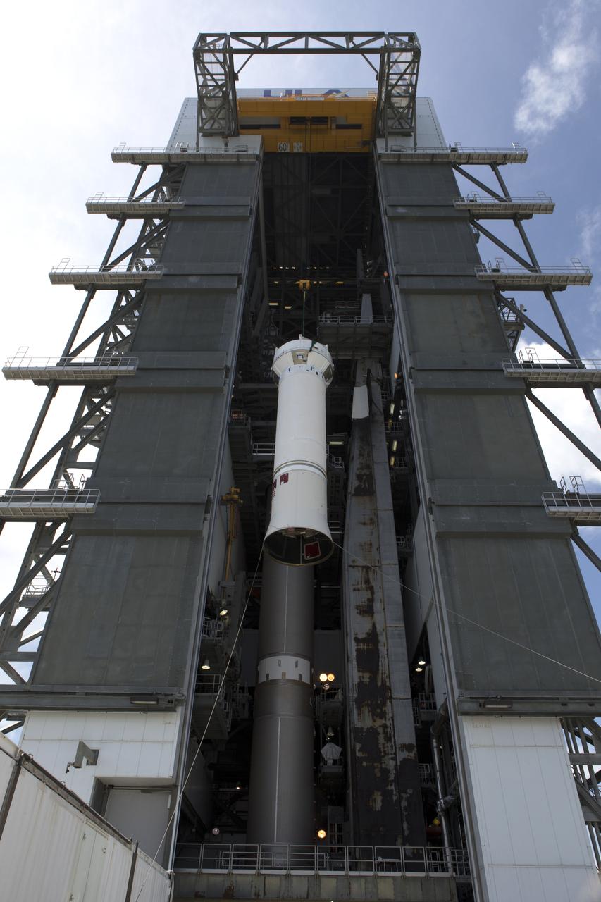 United Launch Alliance team members monitor the progress as the operation begins to lift the Centaur upper stage for mating to its Atlas V booster in the vertical position at the Vertical Integration Facility at Space Launch Complex 41 at Cape Canaveral Air Force Station in Florida. The rocket is scheduled to launch the Tracking and Data Relay Satellite, TDRS-M. It will be the latest spacecraft destined for the agency's constellation of communications satellites that allows nearly continuous contact with orbiting spacecraft ranging from the International Space Station and Hubble Space Telescope to the array of scientific observatories. Liftoff atop the ULA Atlas V rocket is scheduled to take place from Cape Canaveral's Space Launch Complex 41 in early August.
