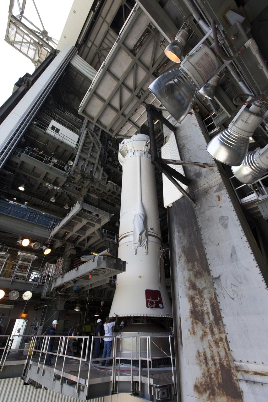 At the Vertical Integration Facility at Space Launch Complex 41 at Cape Canaveral Air Force Station in Florida, United Launch Alliance team members monitor progress as a Centaur upper stage is positioned prior to mating to an Atlas V booster. The rocket is scheduled to launch the Tracking and Data Relay Satellite, TDRS-M. It will be the latest spacecraft destined for the agency's constellation of communications satellites that allows nearly continuous contact with orbiting spacecraft ranging from the International Space Station and Hubble Space Telescope to the array of scientific observatories. Liftoff atop the ULA Atlas V rocket is scheduled to take place from Cape Canaveral's Space Launch Complex 41 in early August.