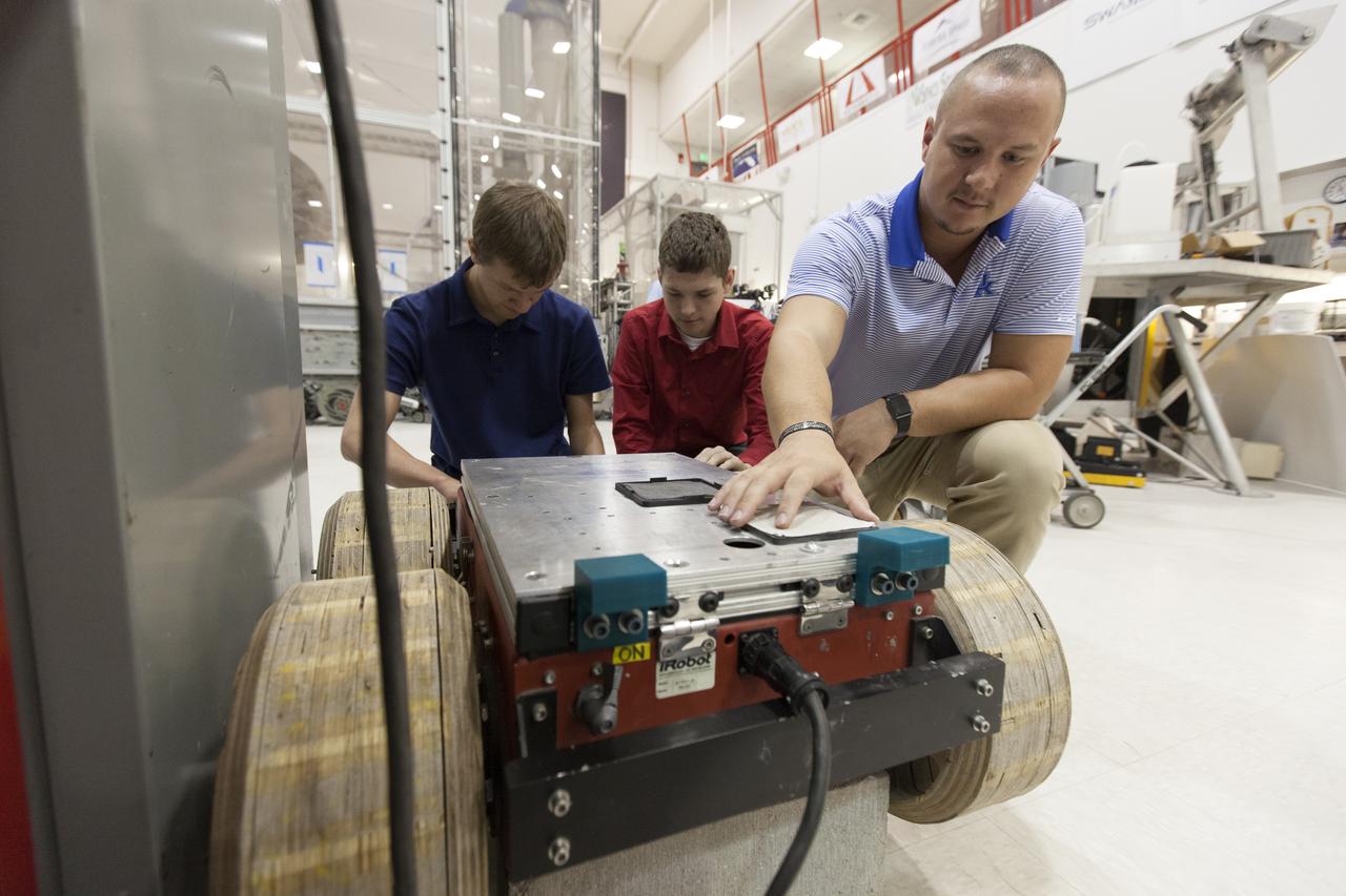 In the Swamp Works laboratory at NASA's Kennedy Space Center in Florida, student interns, from the left, Jeremiah House, Thomas Muller and Austin Langdon are joining agency scientists, contributing in the area of Exploration Research and Technology. House is studying computer/electrical engineering at John Brown University in Siloam Springs, Arkansas. Muller is pursuing a degree in computer engineering and control systems and Florida Tech. Langdon is an electrical engineering major at the University of Kentucky. The agency attracts its future workforce through the NASA Internship, Fellowships and Scholarships, or NIFS, Program.