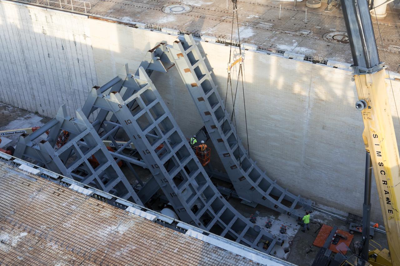 At Launch Pad 39B at NASA's Kennedy Space Center in Florida, large segments of the support hardware for a new flame deflector have been lowered into position in the flame trench. The new flame deflector will be positioned about six feet south of the shuttle-era flame deflector’s position. During liftoff of NASA’s Space Launch System, the rocket’s flame and energy will be diverted to the north side of the flame trench. The north side of the deflector will be protected by a NASA standard coating. The south side of the deflector will not be slanted and will have no lining. The new design will provide easier access for inspection, maintenance and repair. The Ground Systems Development and Operations (GSDO) Program at Kennedy is managing the installation of the flame deflector for Exploration Mission 1, deep space missions, and NASA's Journey to Mars. 