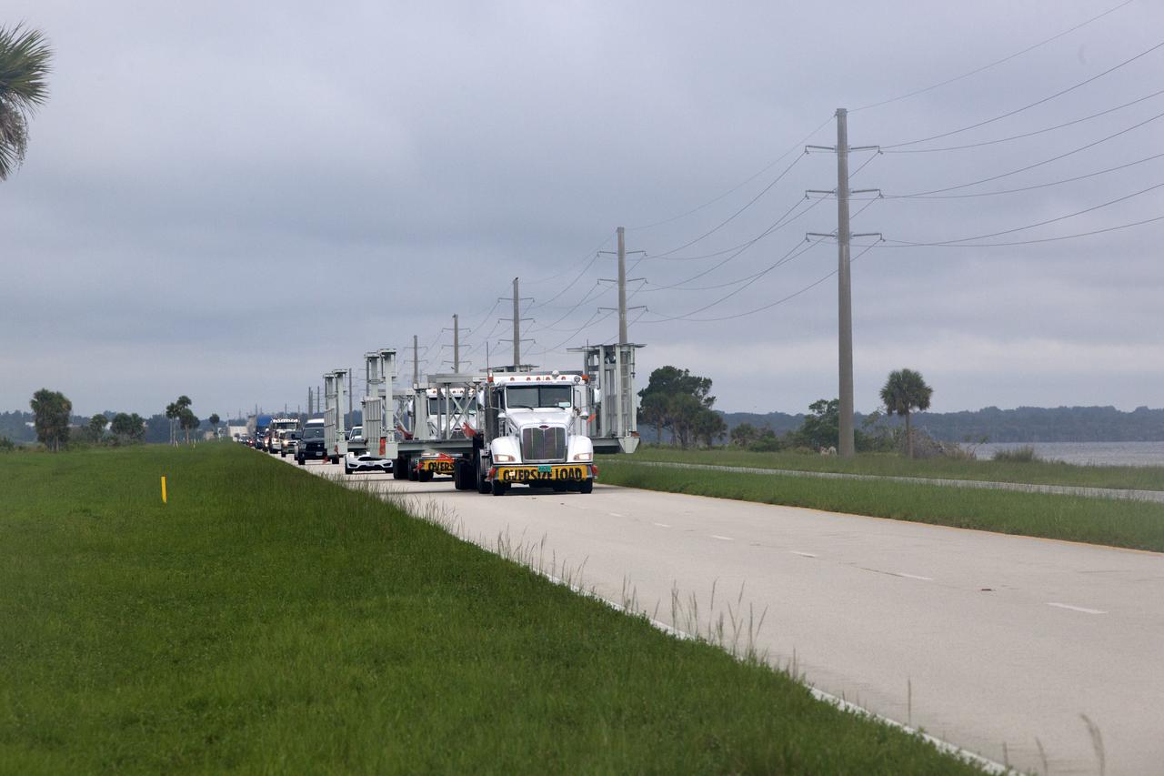 New service platforms for NASA's Space Launch System booster engines, secured on two flatbed trucks, are on their way to the agency's Kennedy Space Center in Florida. They are being transported from fabricator Met-Con Inc. in Cocoa, Florida. The platforms will be delivered to the Vehicle Assembly Building, where they will be stored and used for processing and checkout of the engines for the rocket's twin five-segment solid rocket boosters for Exploration Mission-1. EM-1 will launch an uncrewed Orion spacecraft to a stable orbit beyond the Moon and bring it back to Earth for a splashdown in the Pacific Ocean.