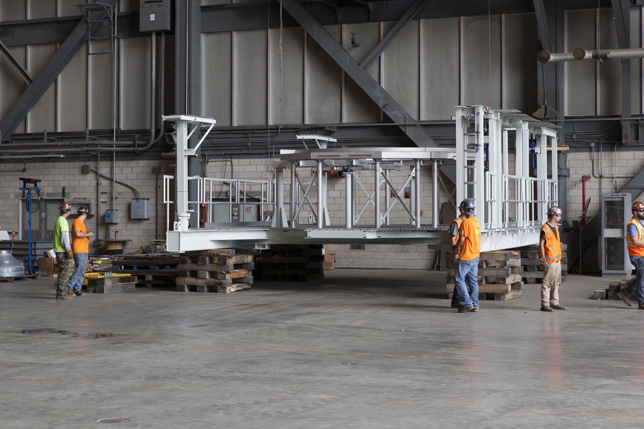 One of two new work platforms for NASA's Space Launch System booster engines is secured on dunnage inside the Vehicle Assembly Building (VAB) at the agency's Kennedy Space Center in Florida. The platforms were transported from fabricator Met-Con Inc. in Cocoa, Florida. They will be stored in the VAB, where they will be used for processing and checkout of the engines for the rocket's twin five-segment solid rocket boosters for Exploration Mission-1. EM-1 will launch an uncrewed Orion spacecraft to a stable orbit beyond the Moon and bring it back to Earth for a splashdown in the Pacific Ocean.